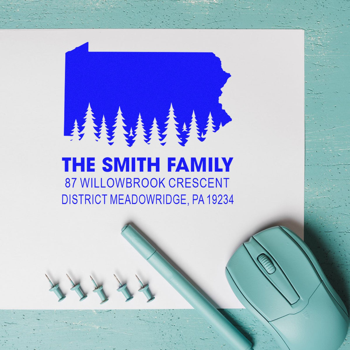Custom self-inking family return address rubber stamp with Pennsylvania silhouette and pine tree design for personalized mailings.