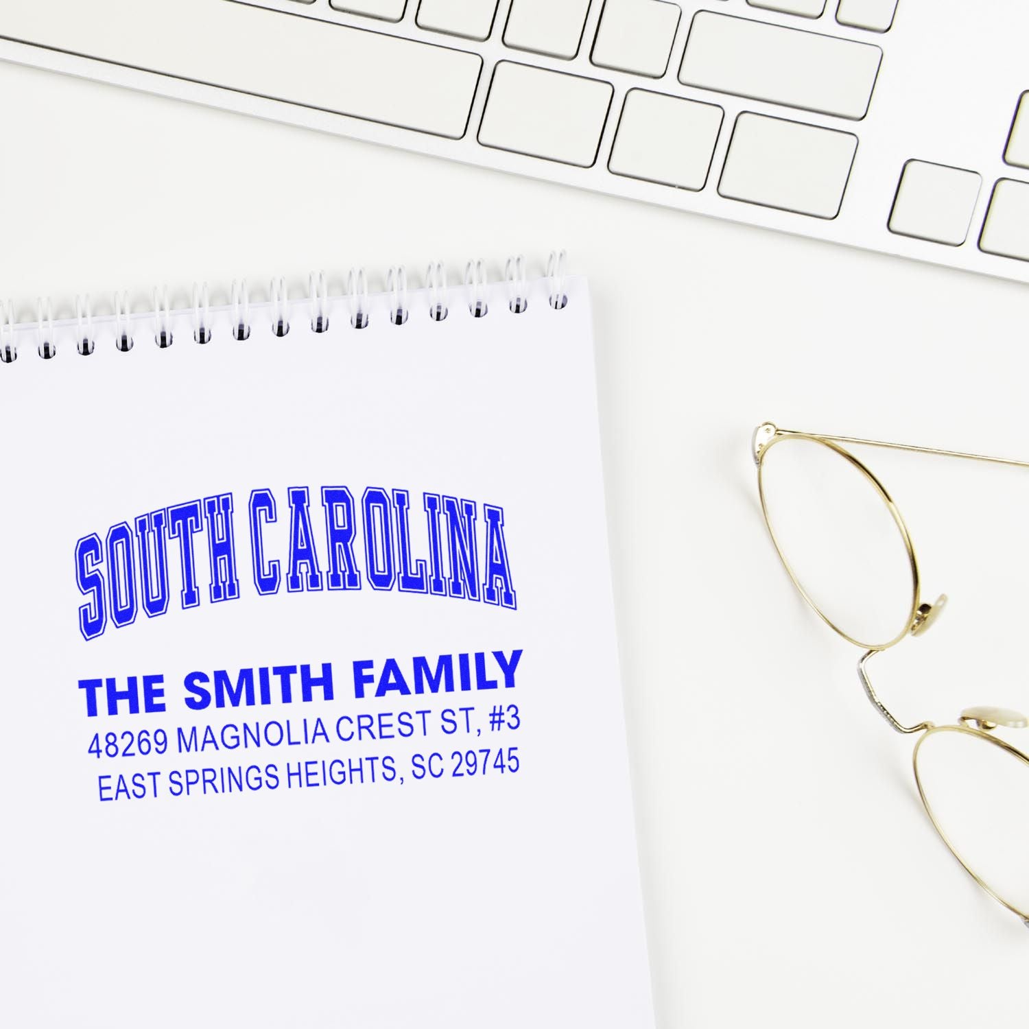 Custom address rubber stamp for a South Carolina family, shown as a blue return address imprint on notebook stationery.