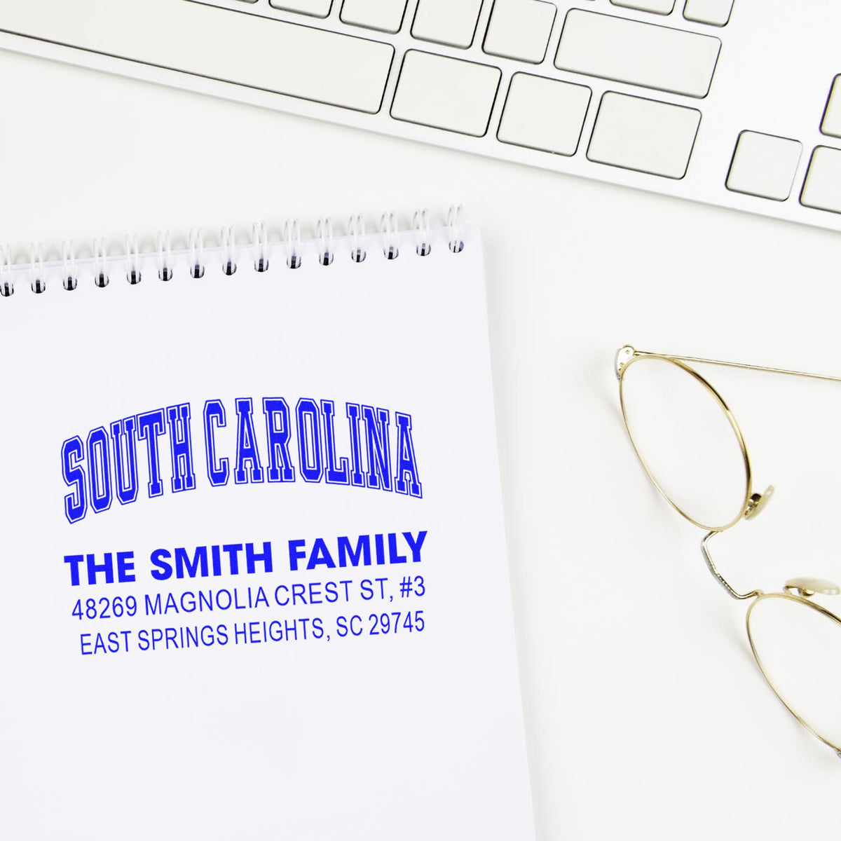 Custom return address rubber stamp for The Smith Family in South Carolina, shown stamped on a notebook page.