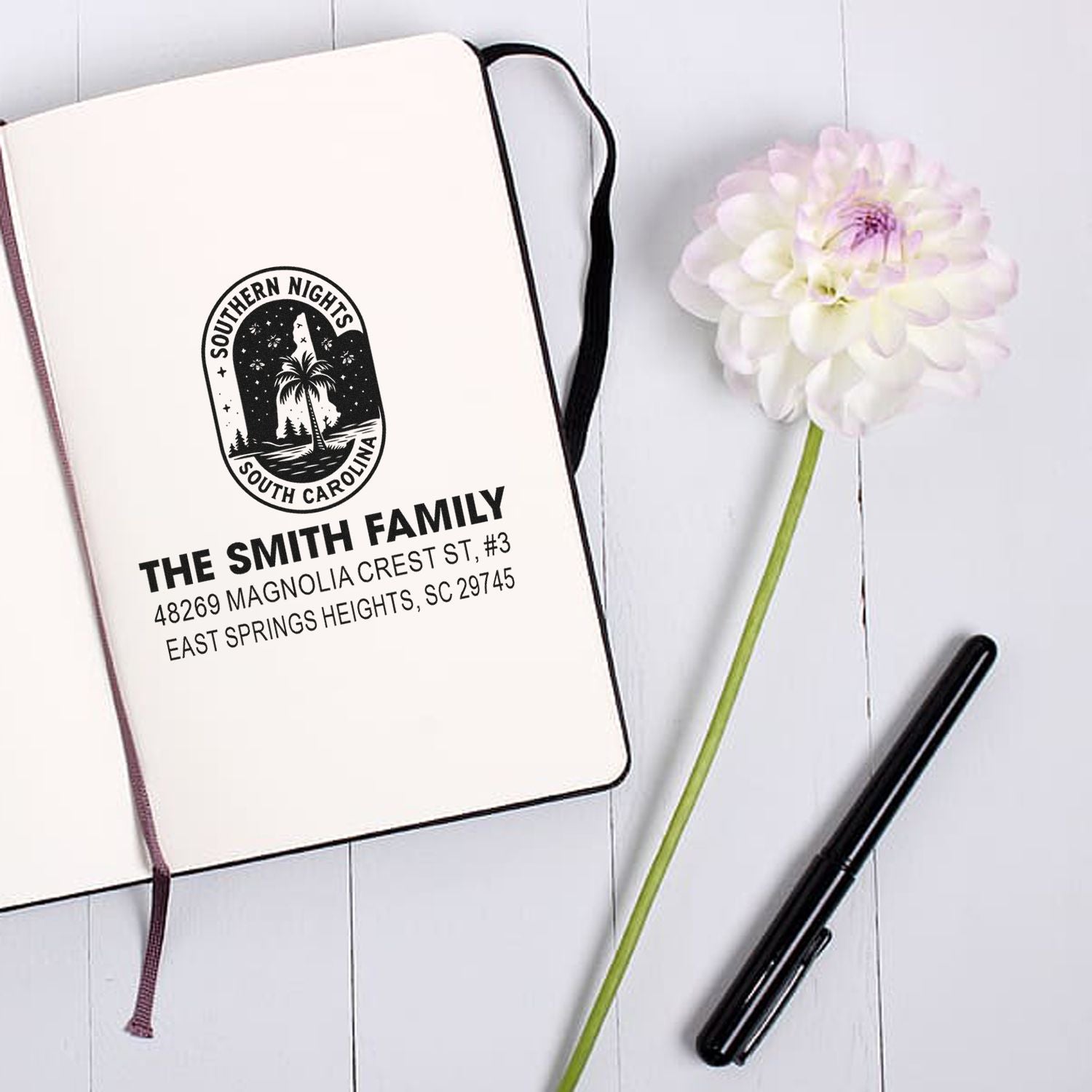 Custom family return address rubber stamp with Southern Nights South Carolina design, shown as a notebook mockup.