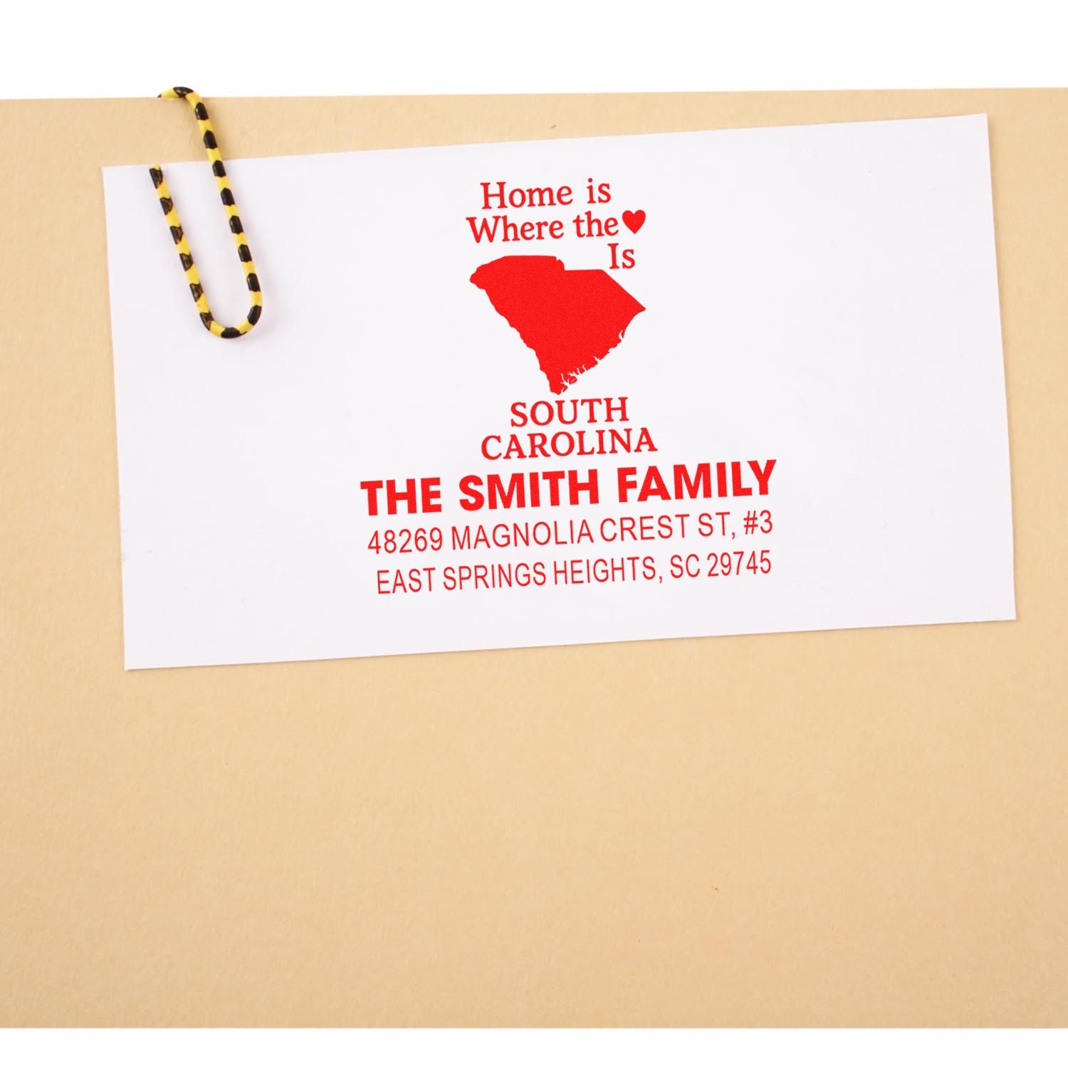 Personalized South Carolina return address rubber stamp with family name and home quote on envelope.