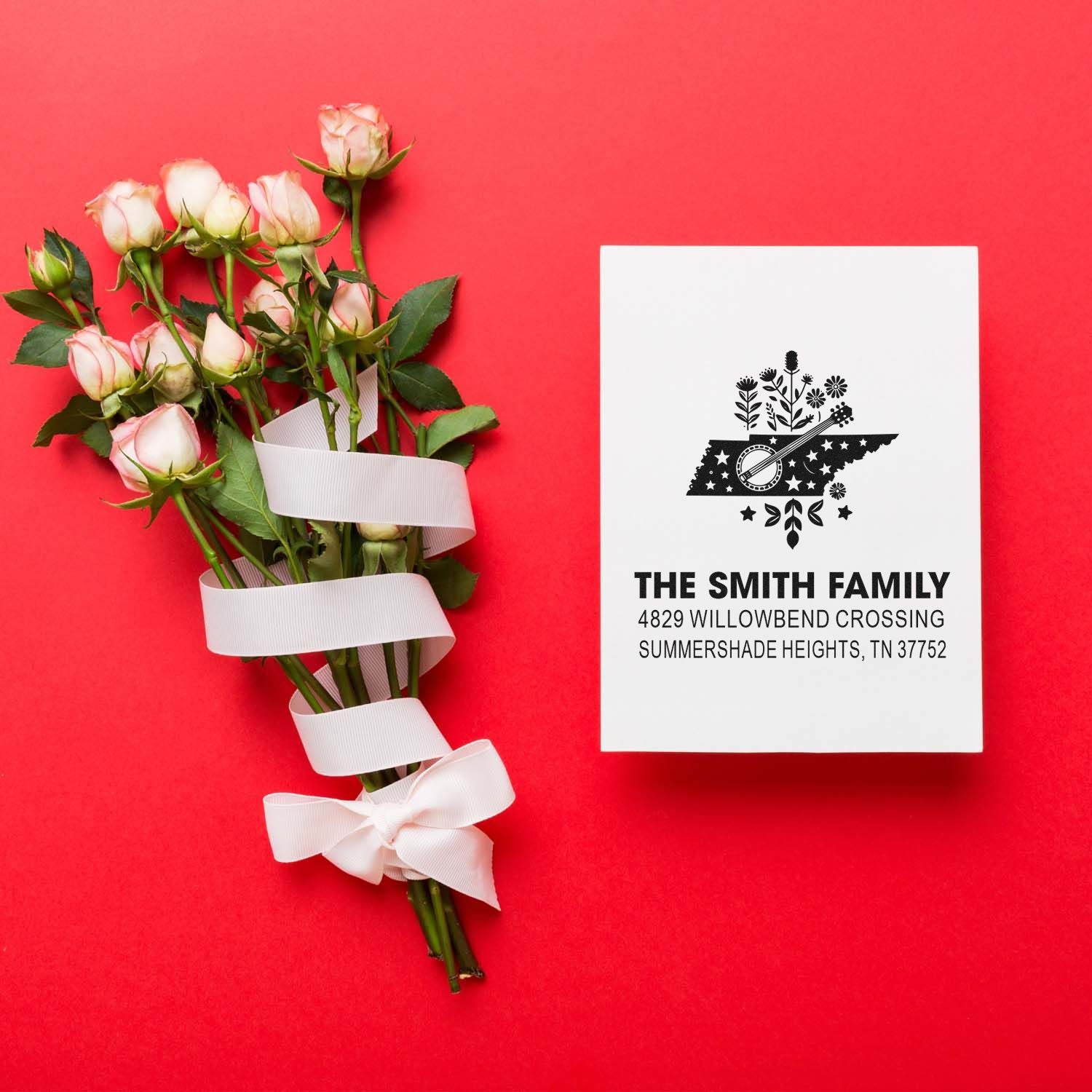 Custom family address rubber stamp design for wedding invitations, shown with roses and a personalized return address card.