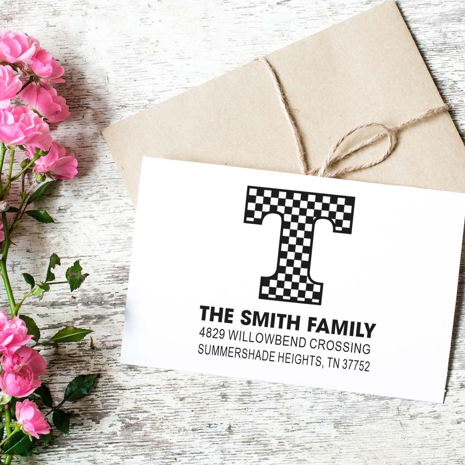 Personalized return address rubber stamp with monogram T for The Smith Family, shown on a custom envelope and card.