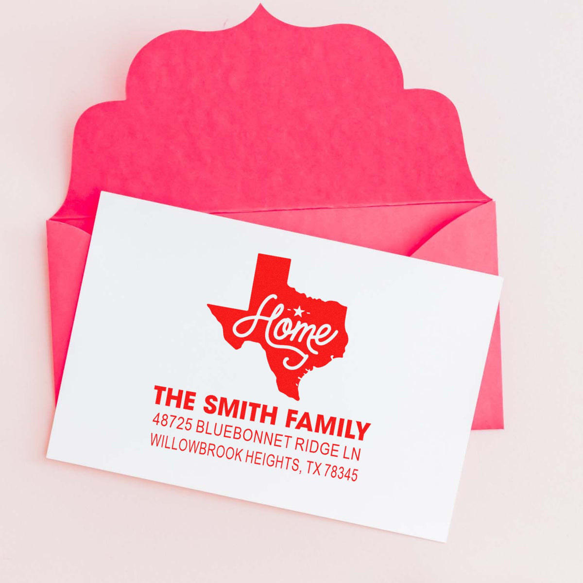 Personalized return address rubber stamp with Texas home design for The Smith Family, shown with pink envelope.
