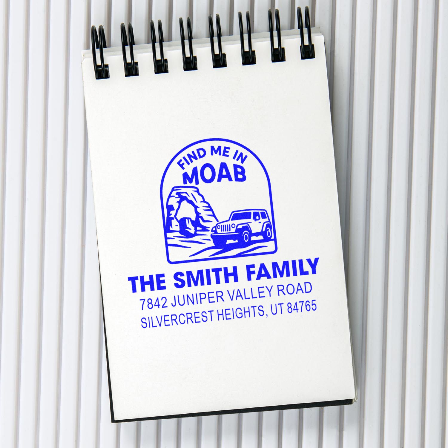 Custom rubber stamp imprint on notepad with Find Me in Moab family address design for personalized stationery.