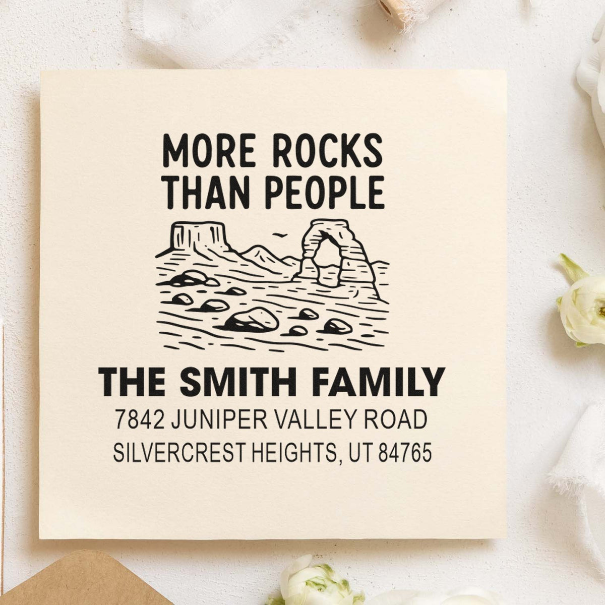 Custom rubber address stamp with mountain scene and More Rocks Than People family name design.