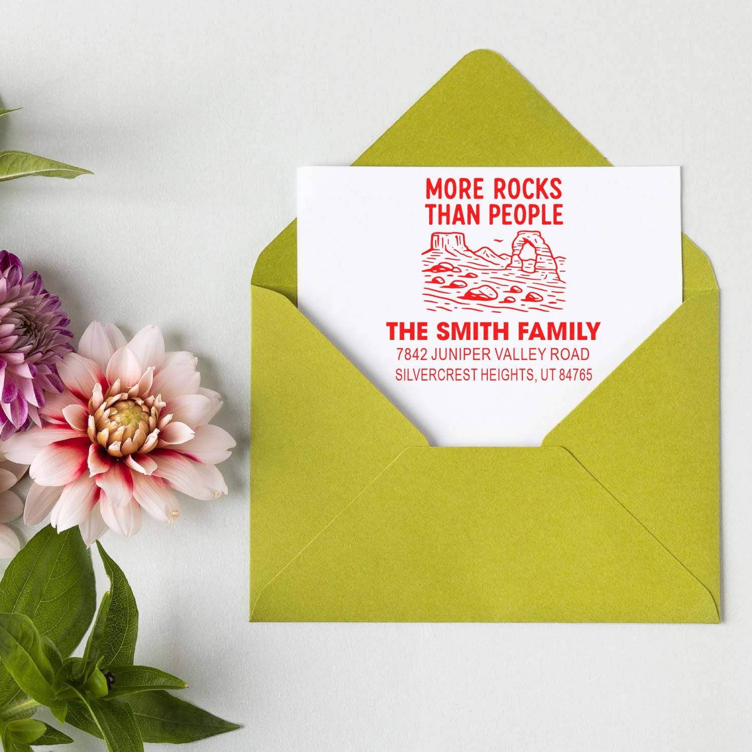 Custom address rubber stamp on envelope with More Rocks Than People desert design for the Smith family.