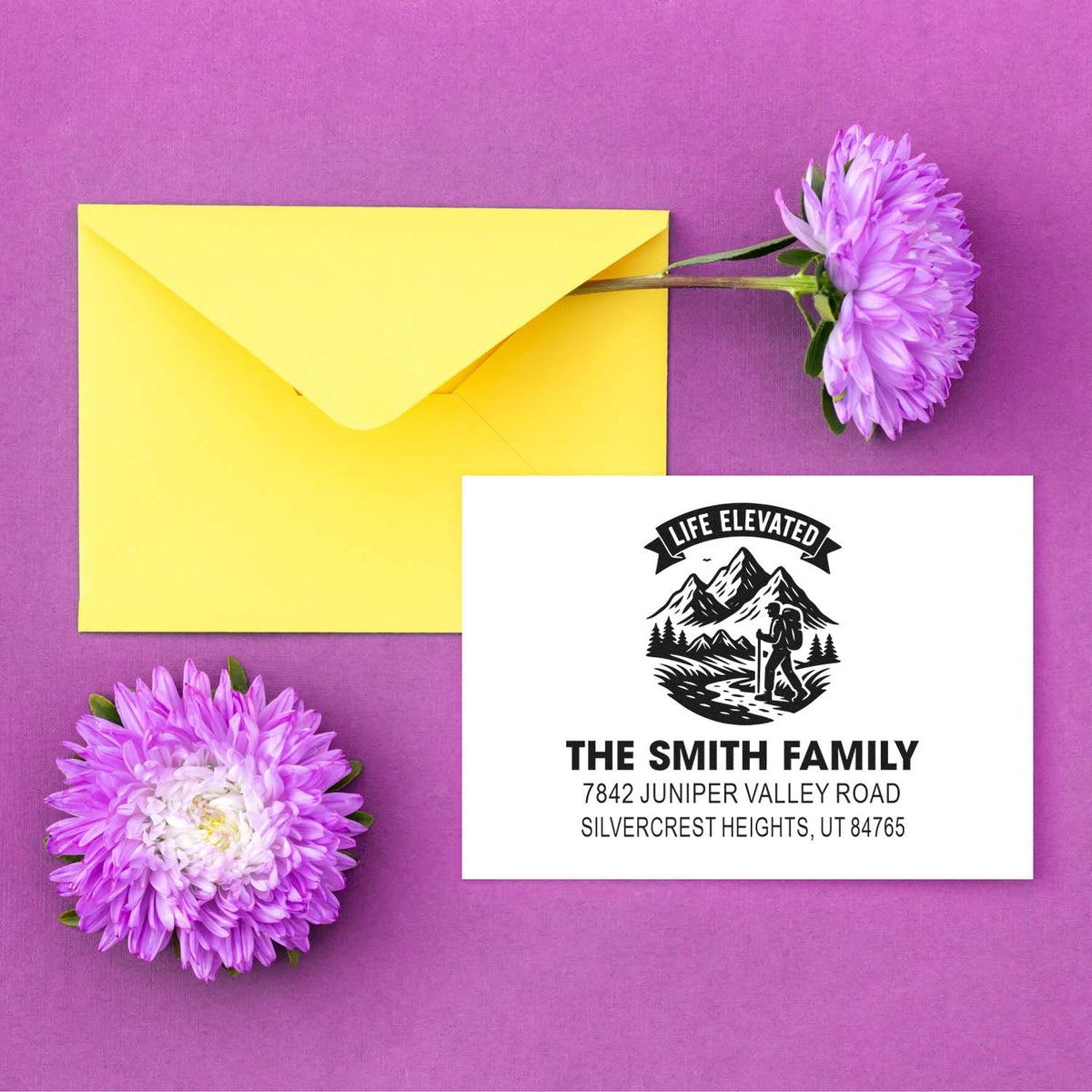 Custom return address rubber stamp for The Smith Family with hiking mountain design, shown on a yellow envelope.