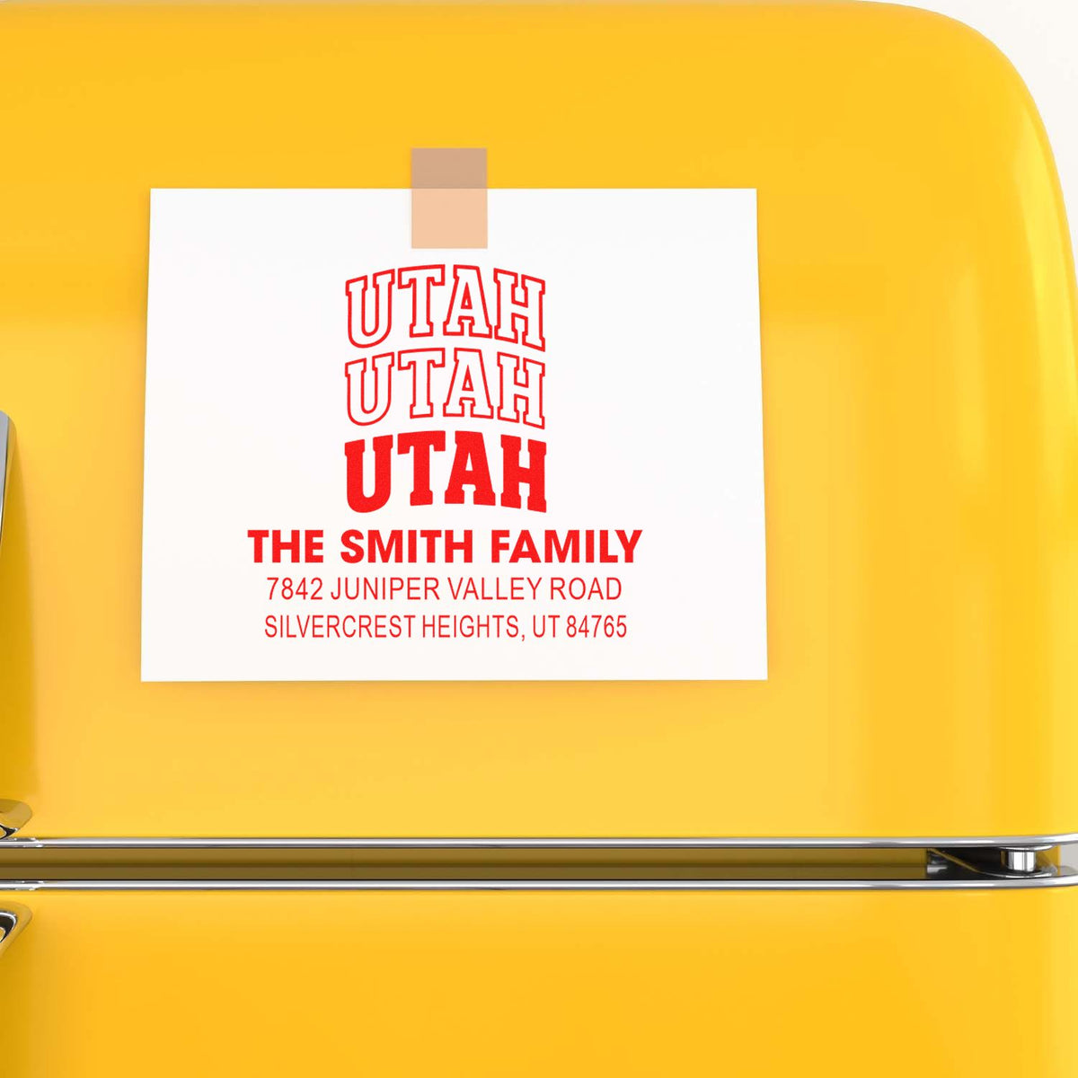 Custom return address rubber stamp for The Smith Family, Utah, with name and address in red on a fridge card.