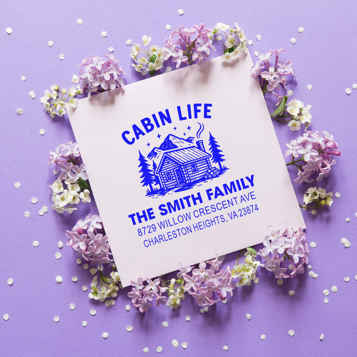 Personalized cabin life return address rubber stamp for the Smith family, shown on a floral purple background.