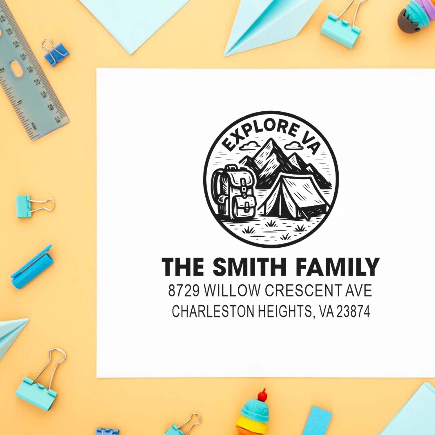 Custom family address stamp with Explore VA camping design, tent and mountains, styled on a pastel desk with stationery.