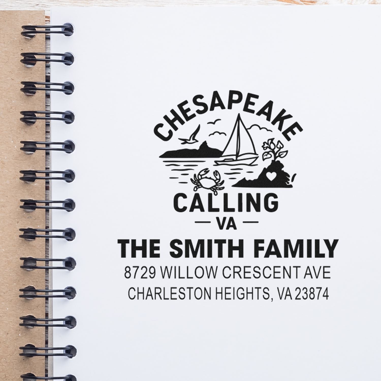 Personalized Chesapeake Calling VA address stamp with sailboat, crab and coastal scene for The Smith Family on a notebook page.