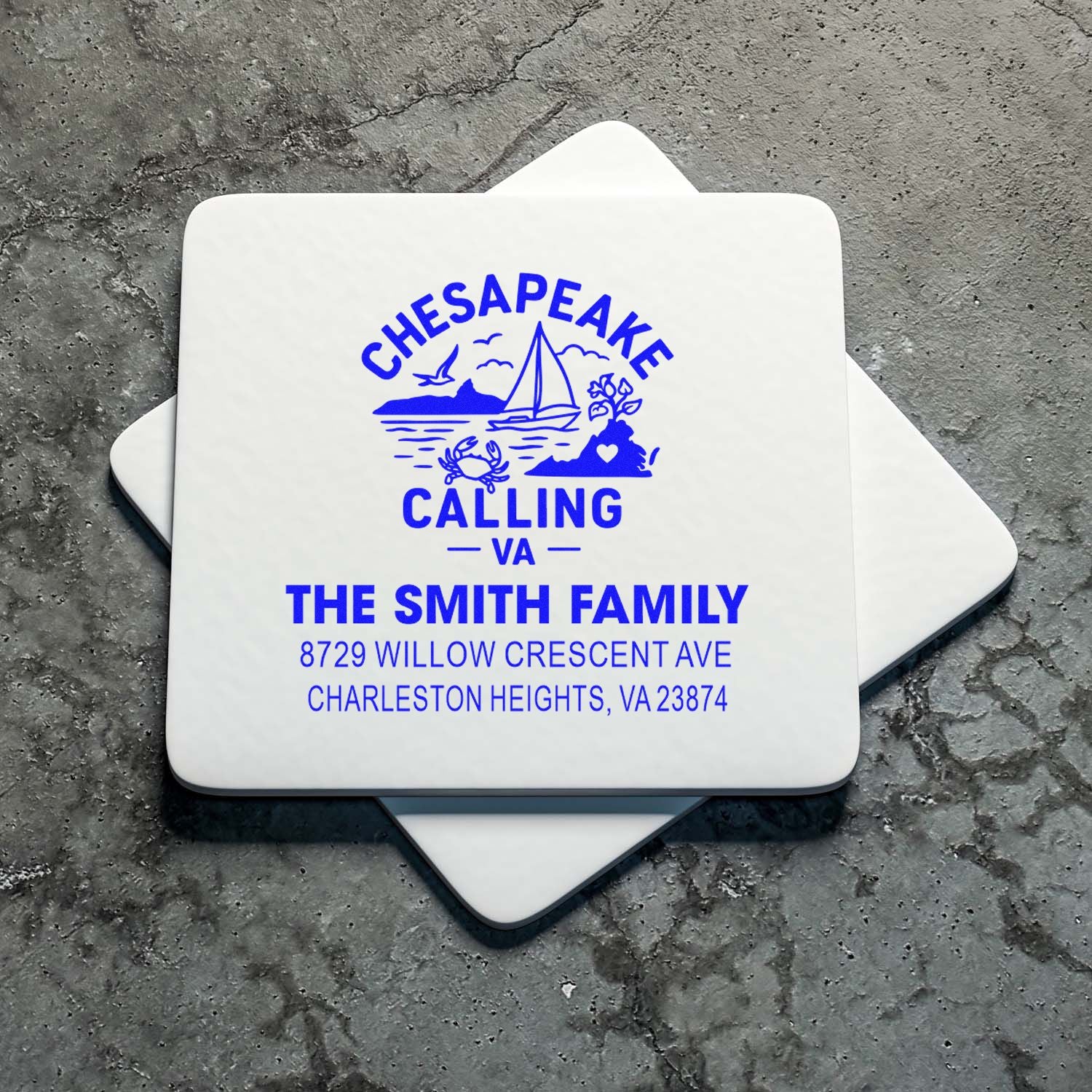 Custom self-inking Chesapeake Calling VA family address stamp with sailboat, crab and coastal design on stacked square stamp blocks.