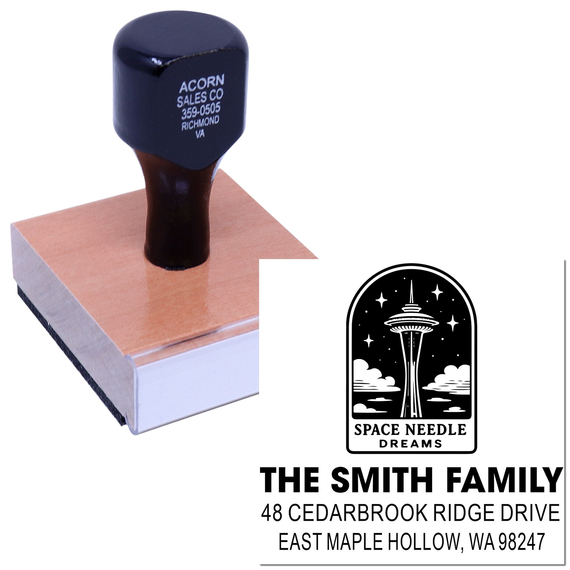 Custom rubber stamp on wooden block pressing a Seattle Space Needle design and family address onto white paper.