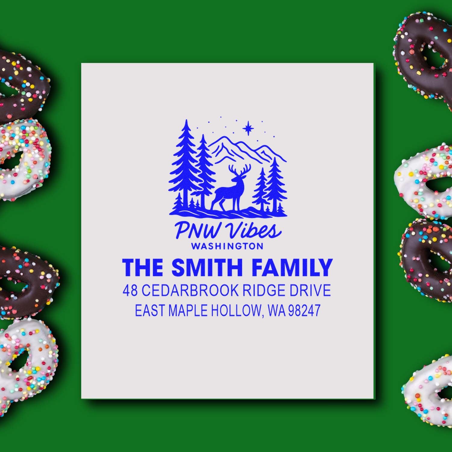 Custom PNW Vibes Washington address stamp with deer, pine trees, mountains and The Smith Family return address on green background with sprinkled donuts.