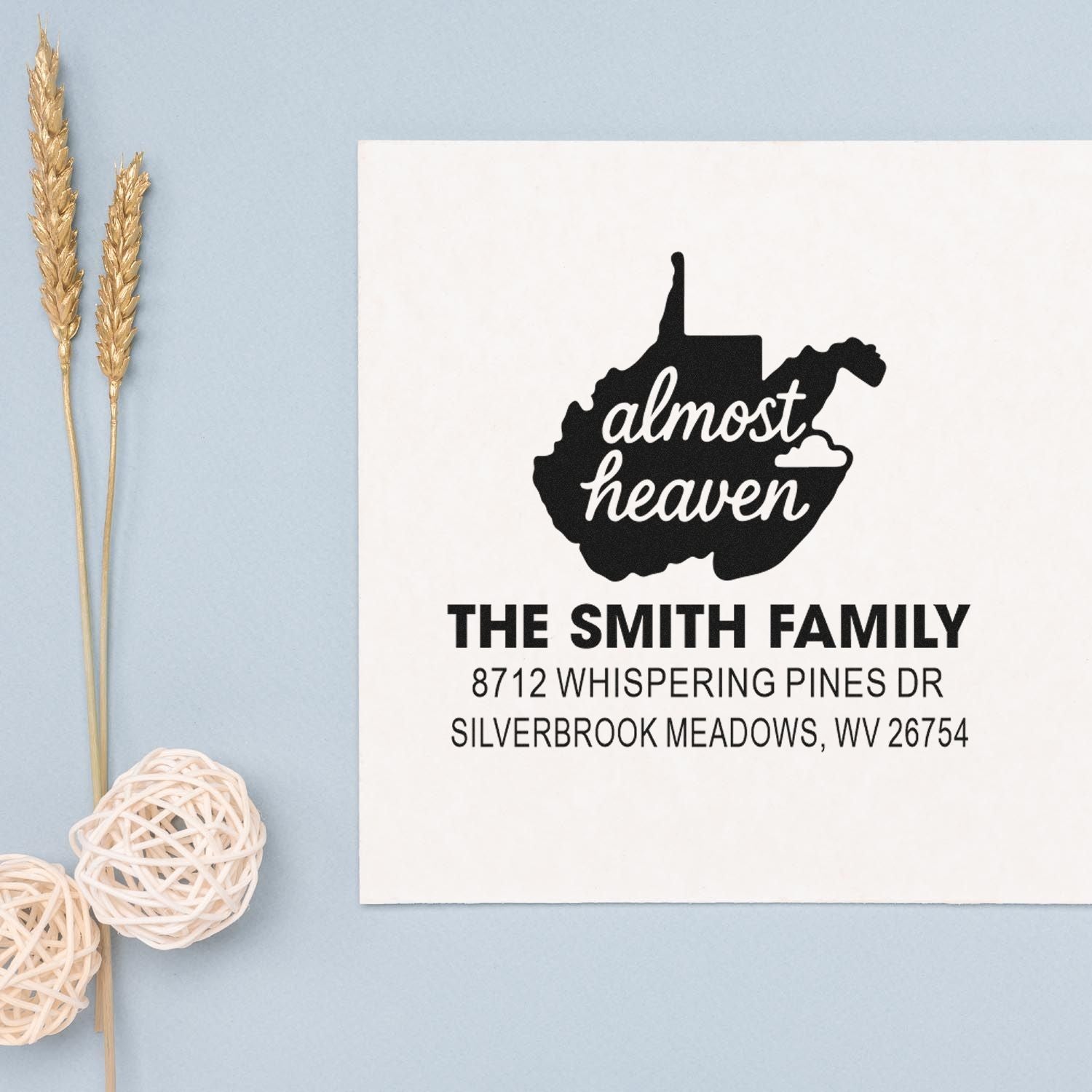 Custom West Virginia return address stamp with almost heaven state silhouette, The Smith Family name, on a white card with wheat decor.