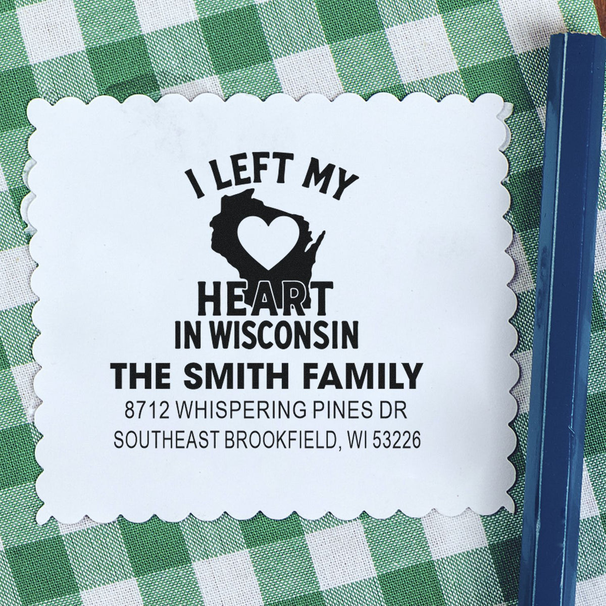 Custom return address stamp with I Left My Heart in Wisconsin and The Smith Family address, on green checkered cloth.