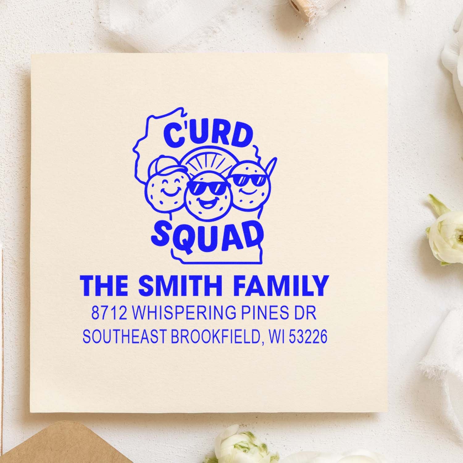 Custom blue Curd Squad address stamp for The Smith Family, featuring cartoon cheese graphic and Brookfield, WI address on beige paper.