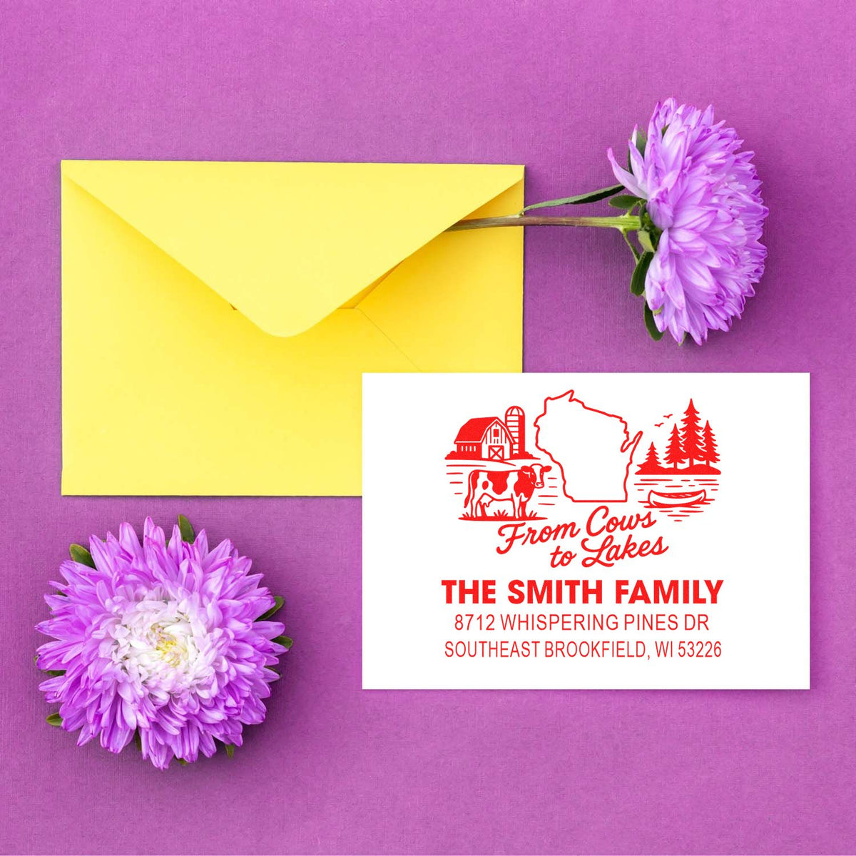 Custom family address stamp beside a yellow envelope and purple flowers on a purple backdrop, with Wisconsin return address and barn graphic.