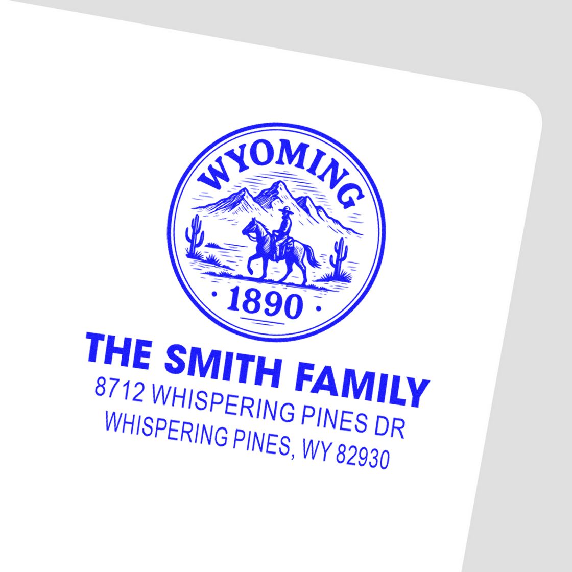 Blue Wyoming return address stamp for The Smith Family, with cowboy seal, mountains, and Whispering Pines, WY address.