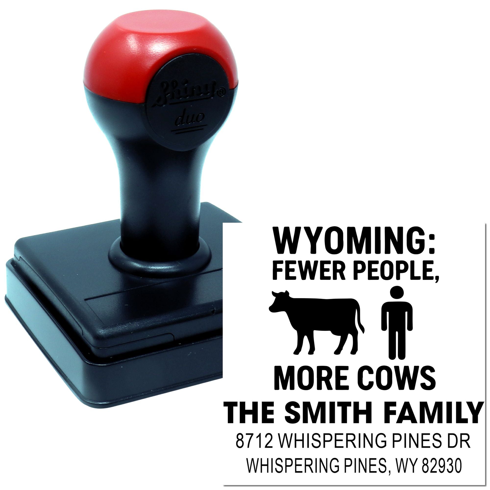Custom self-inking stamp on white background with Wyoming slogan: Fewer People, More Cows, plus The Smith Family address.