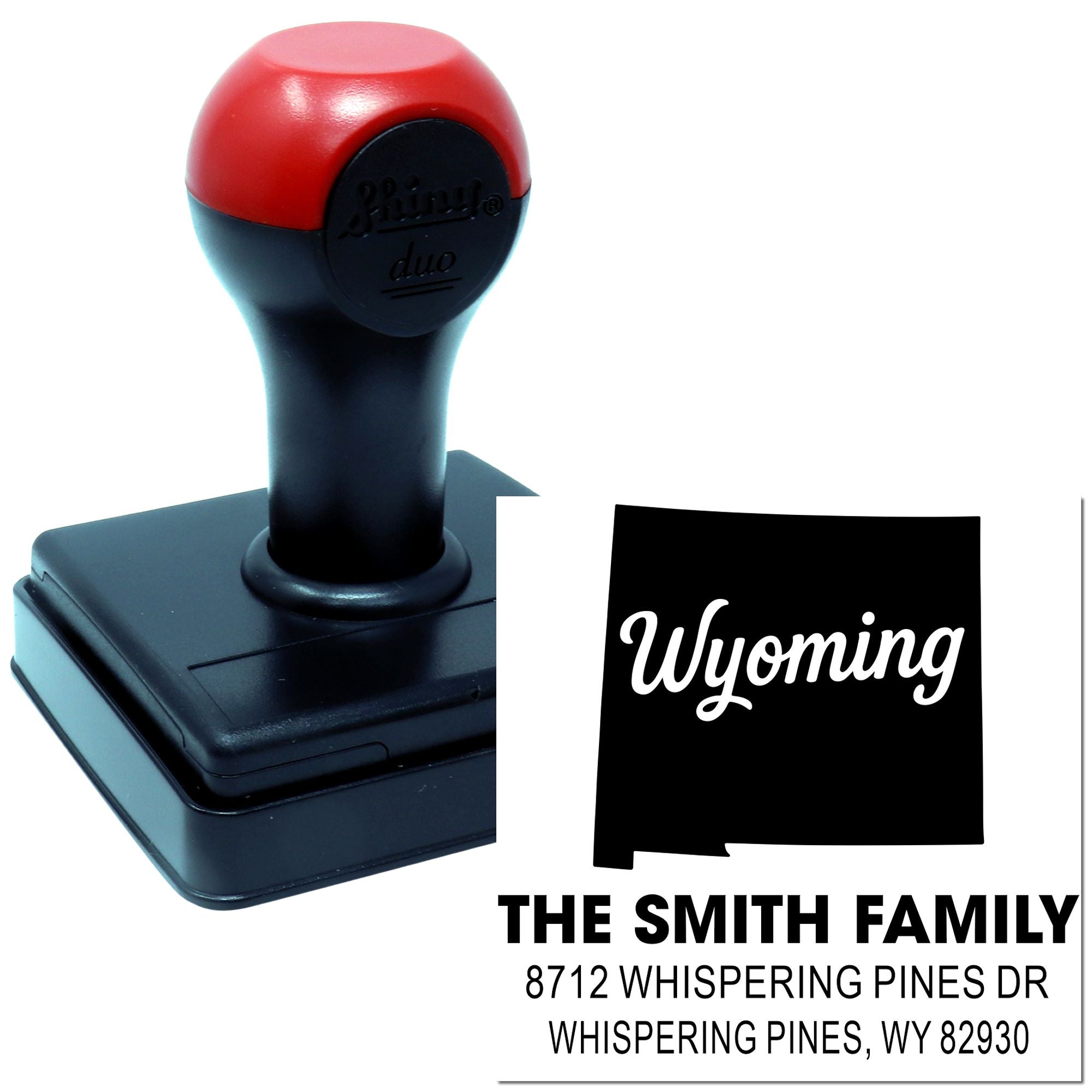 Self-inking Wyoming address stamp for The Smith Family, shown with red-and-black stamp body and custom return address on a white background.