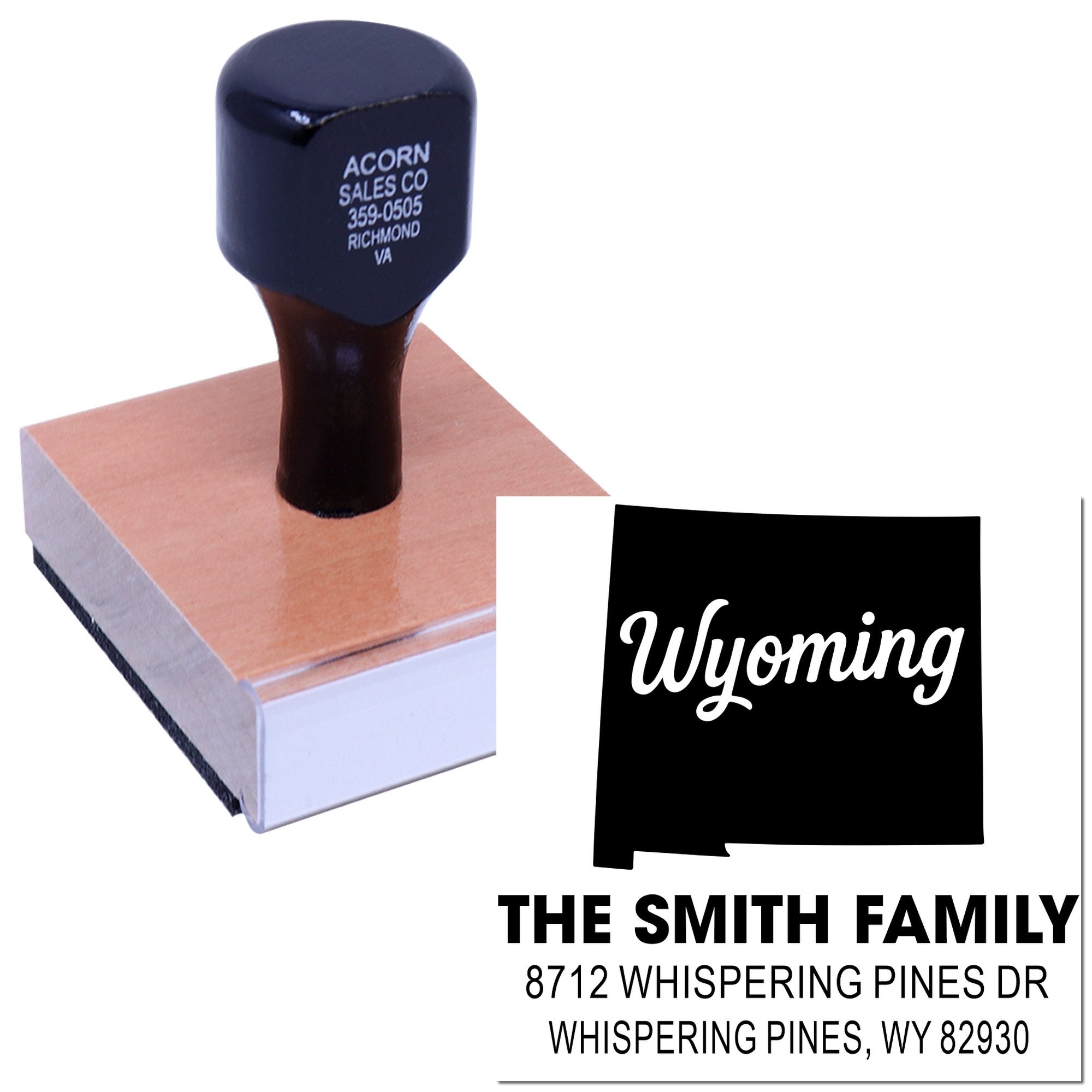 Custom self-inking address stamp with Wyoming state design, shown on a block with sample imprint for The Smith Family and Whispering Pines address.