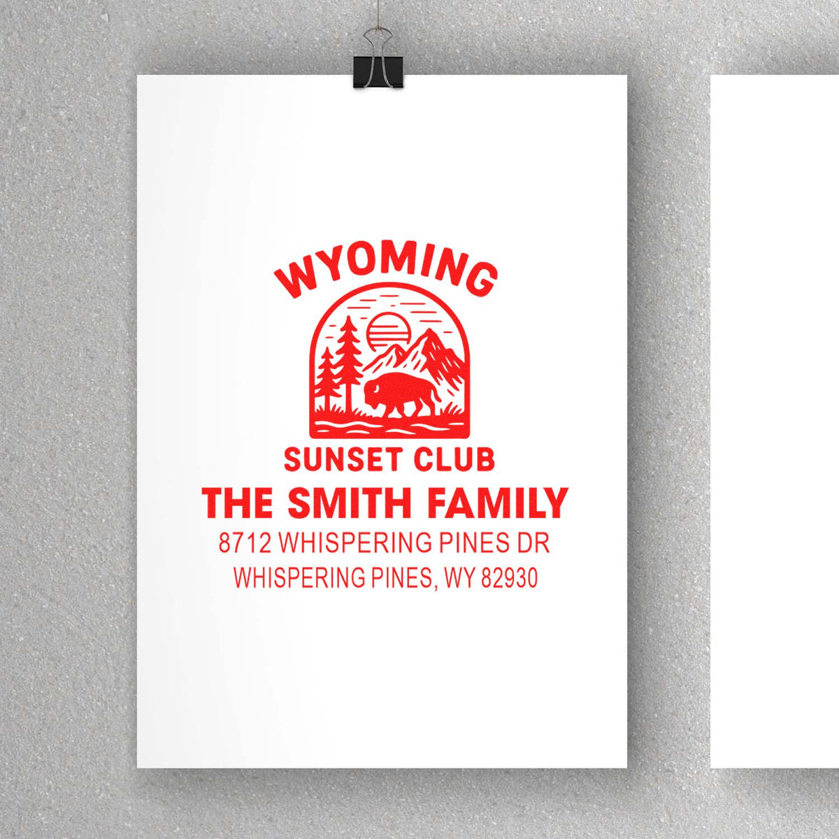 Custom red Wyoming Sunset Club address stamp on white paper, featuring bison, mountains and pine trees for The Smith Family.