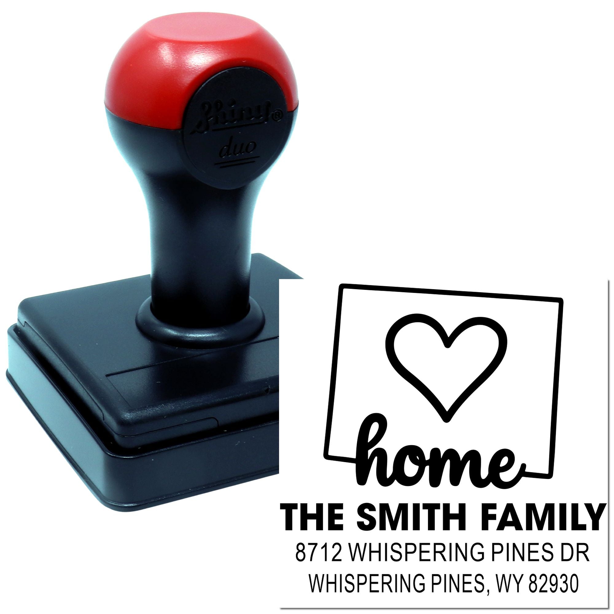 Custom self-inking address stamp with heart home design, The Smith Family and Whispering Pines, WY address on a red-and-black stamp handle.