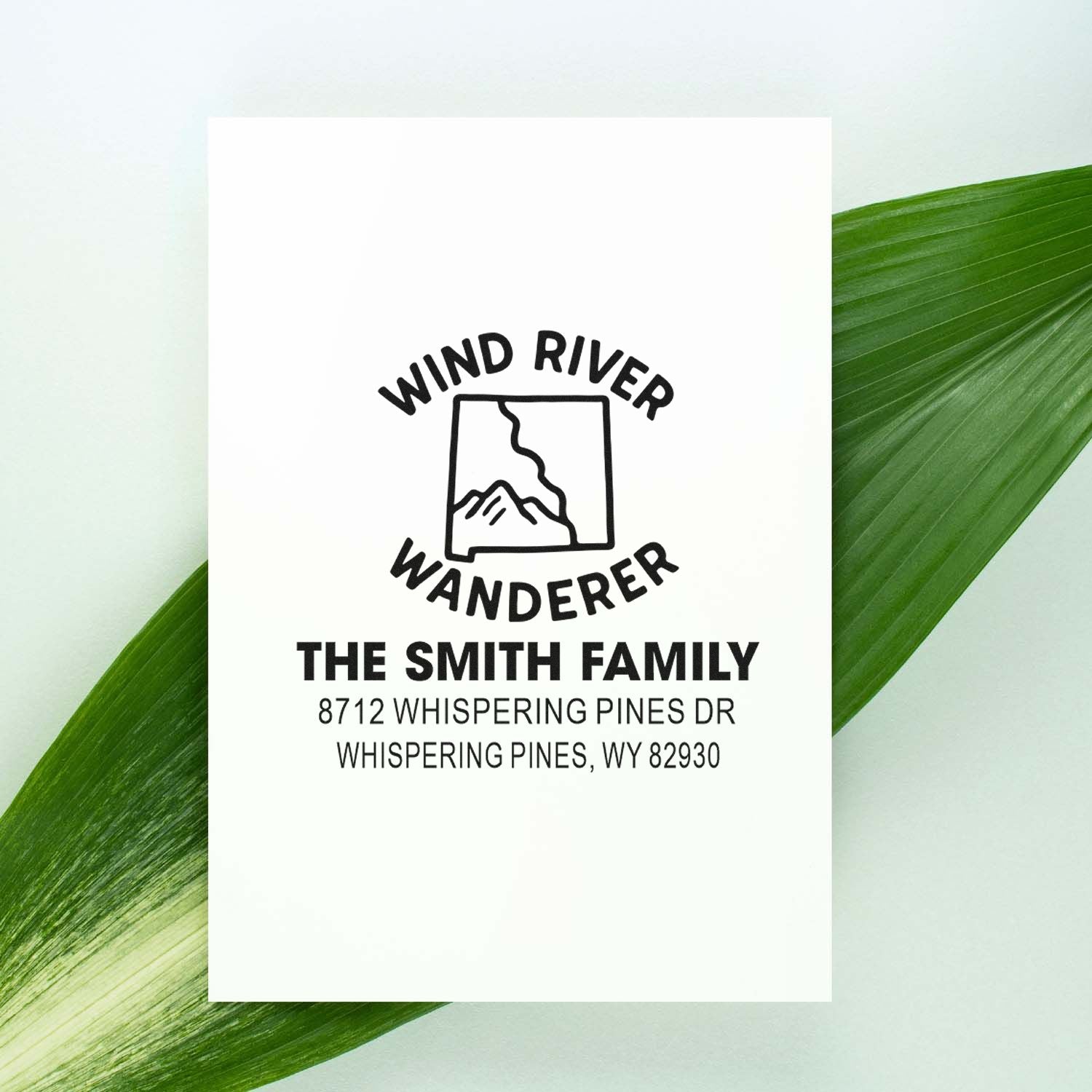 Personalized Wind River Wanderer return address stamp for The Smith Family, shown on a white card with green leaf background.