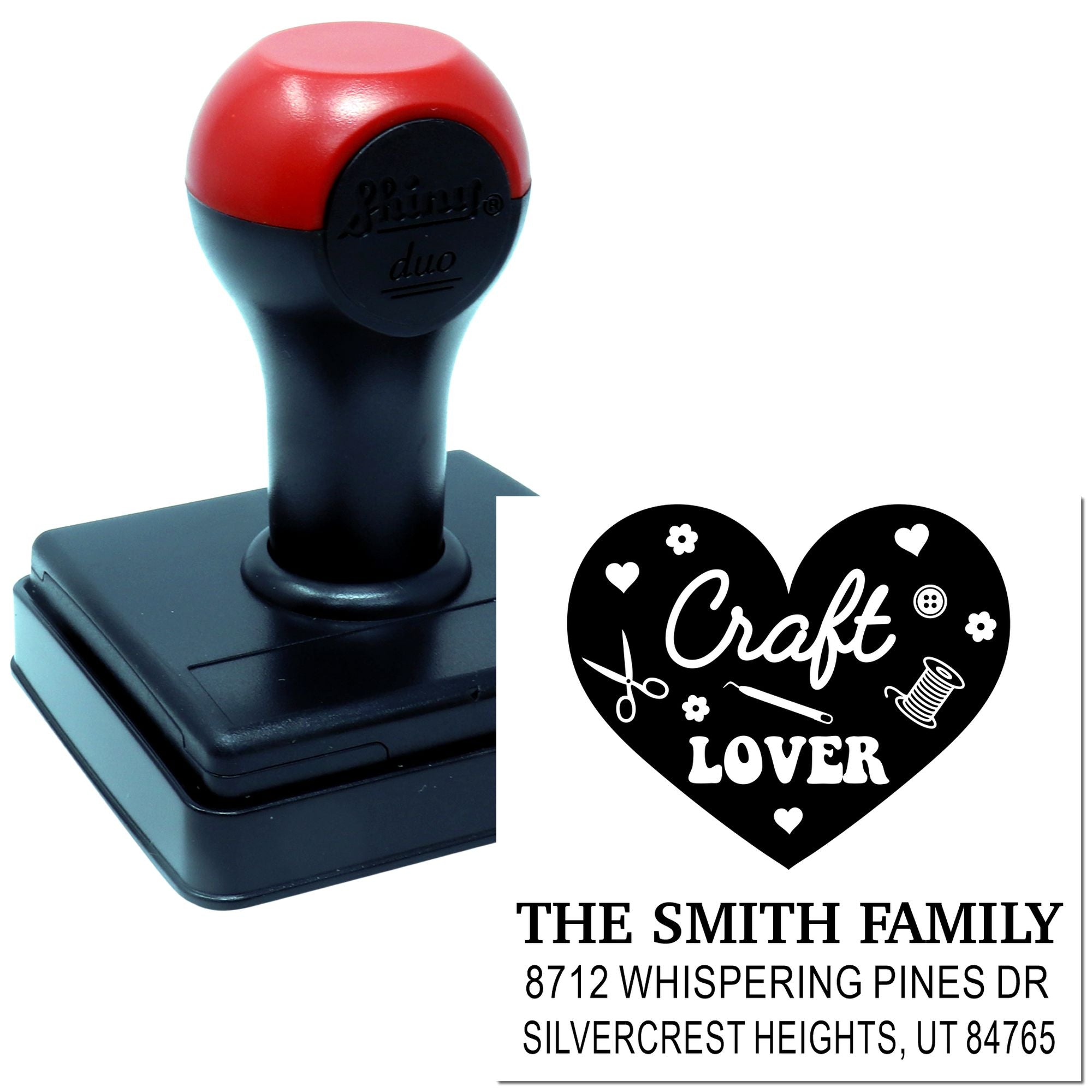 Custom self-inking craft stamp with heart design, decorative icons, and family address text on a white background.
