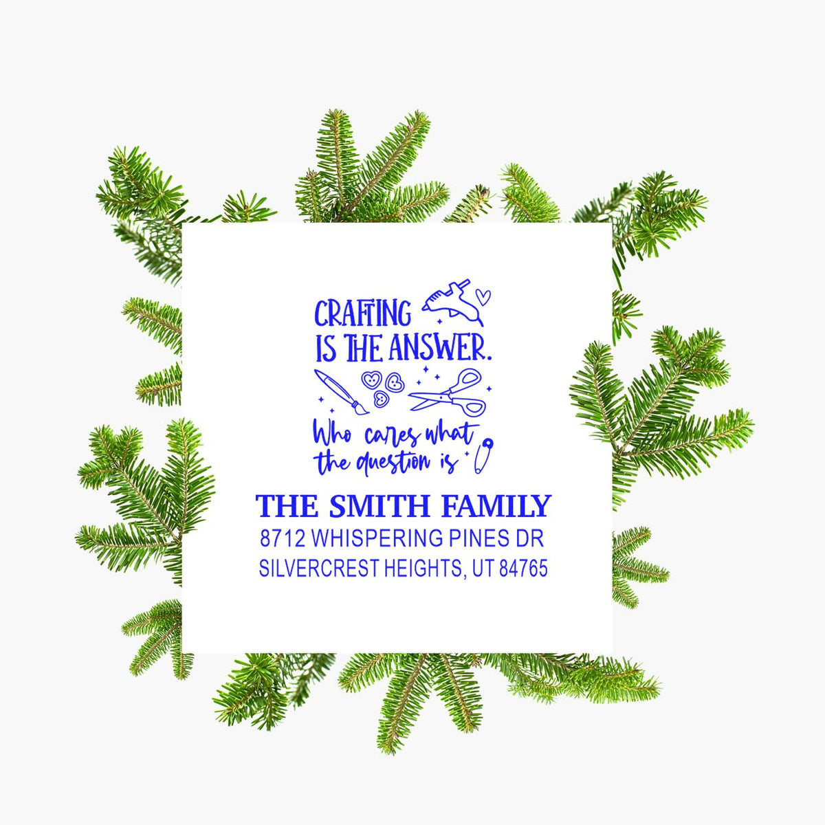 Custom return address stamp with Crafting is the answer quote, blue text, and Smith family address, framed by pine branches on a white background.