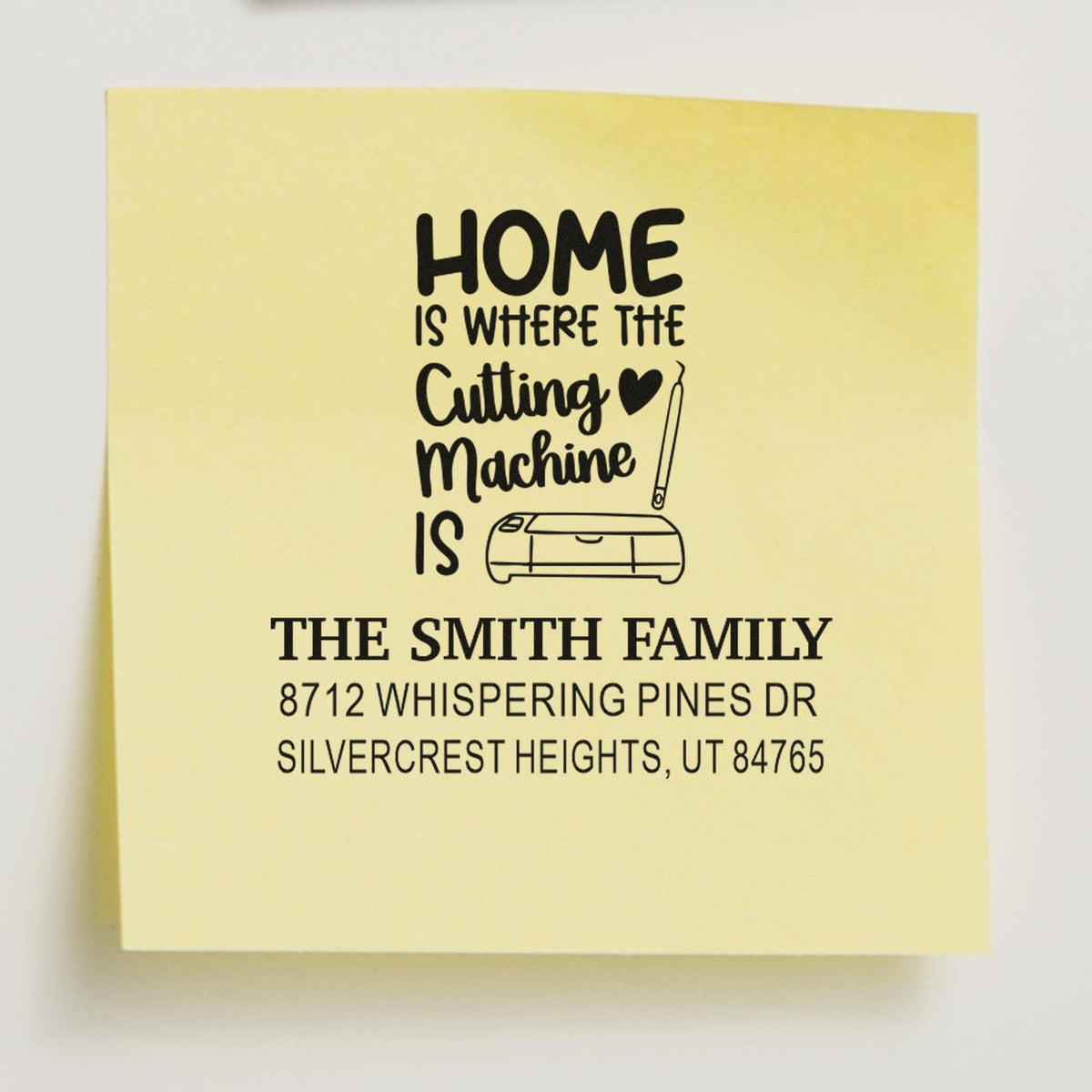 Custom return address stamp with Home is where the cutting machine is design, cutter icon, and The Smith Family address on a yellow stamp block.