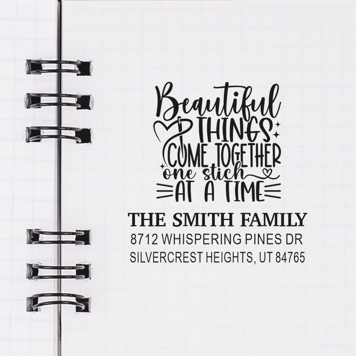 Custom address and quote stamp on a planner page, featuring Beautiful things come together one stitch at a time and The Smith Family address.