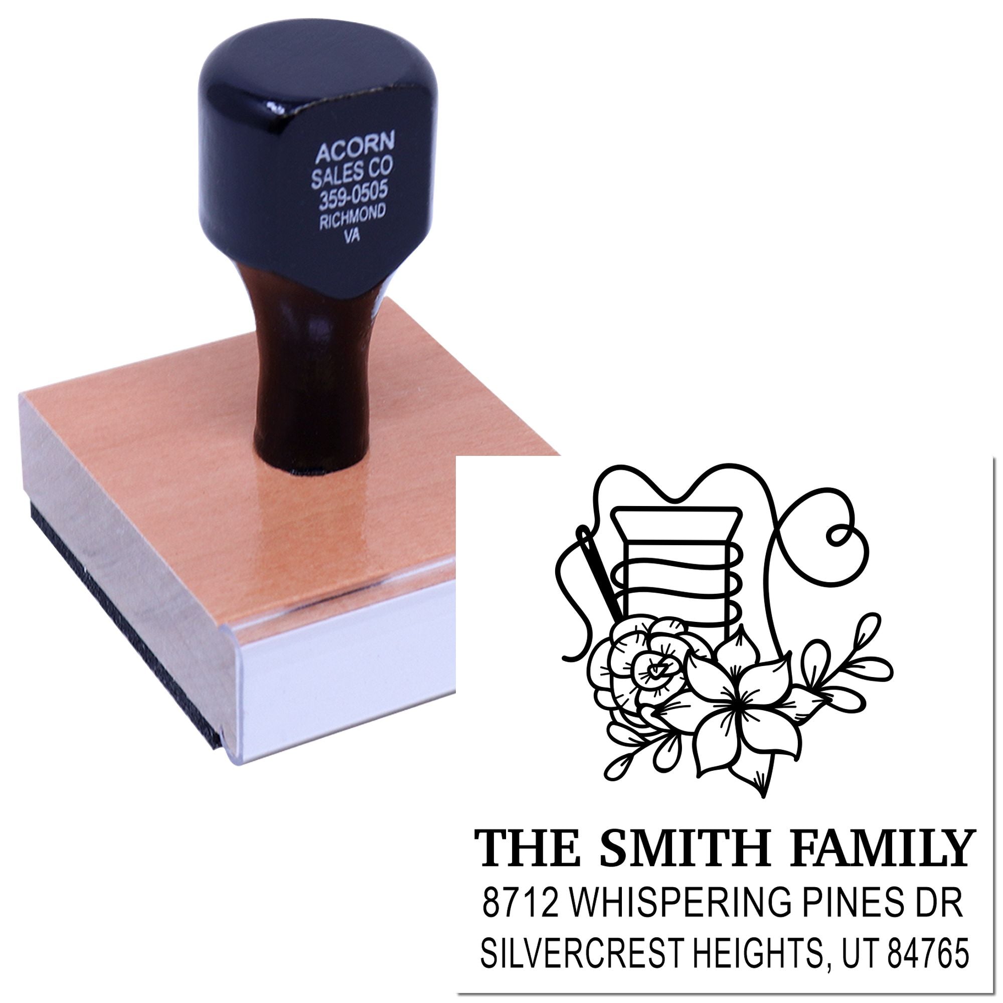 Custom self-inking address stamp with floral monogram, family name and address, shown pressed on an ink pad with sample imprint.