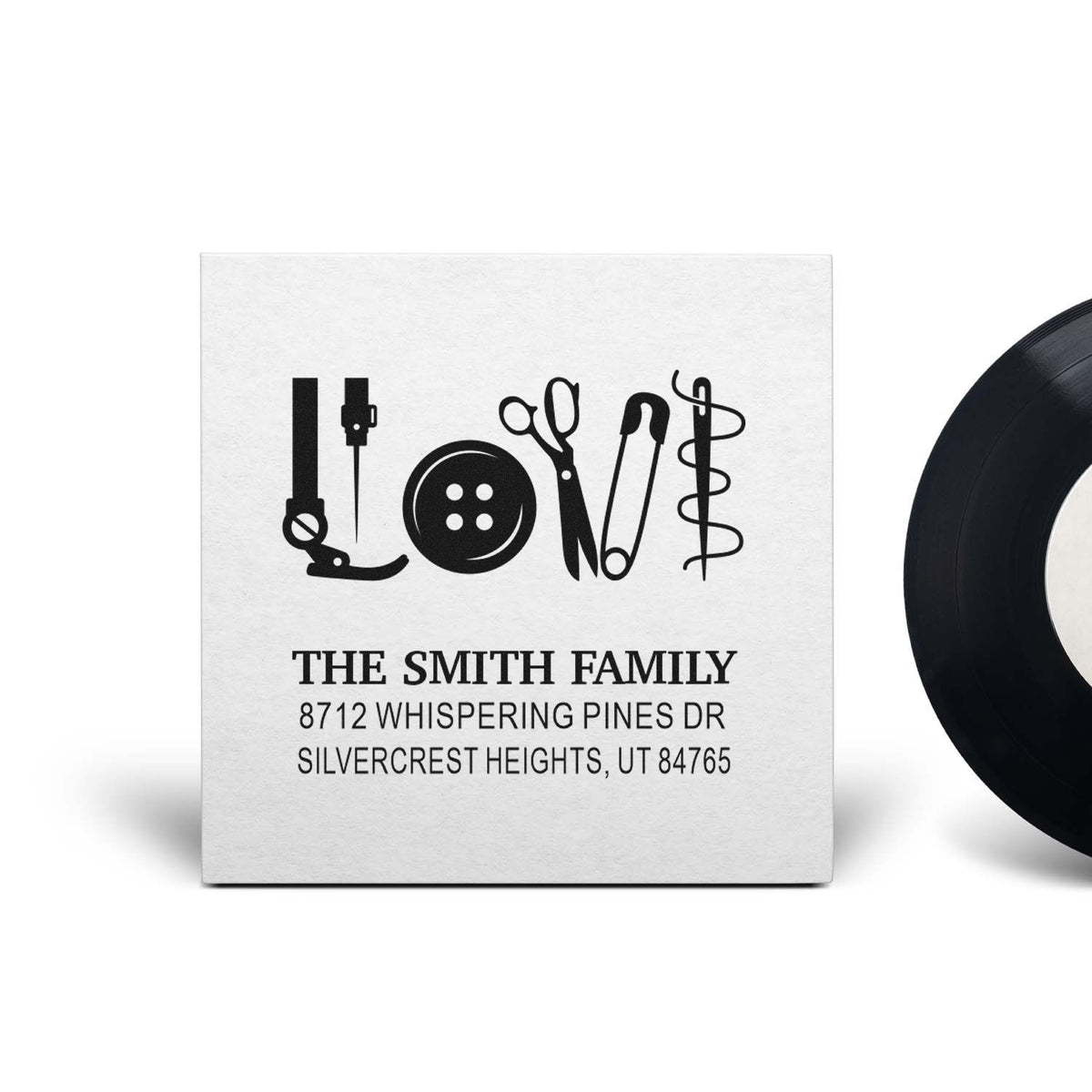 Custom self-inking family address stamp with sewing tools spelling LOVE, featuring The Smith Family and Silvercrest Heights, UT address.