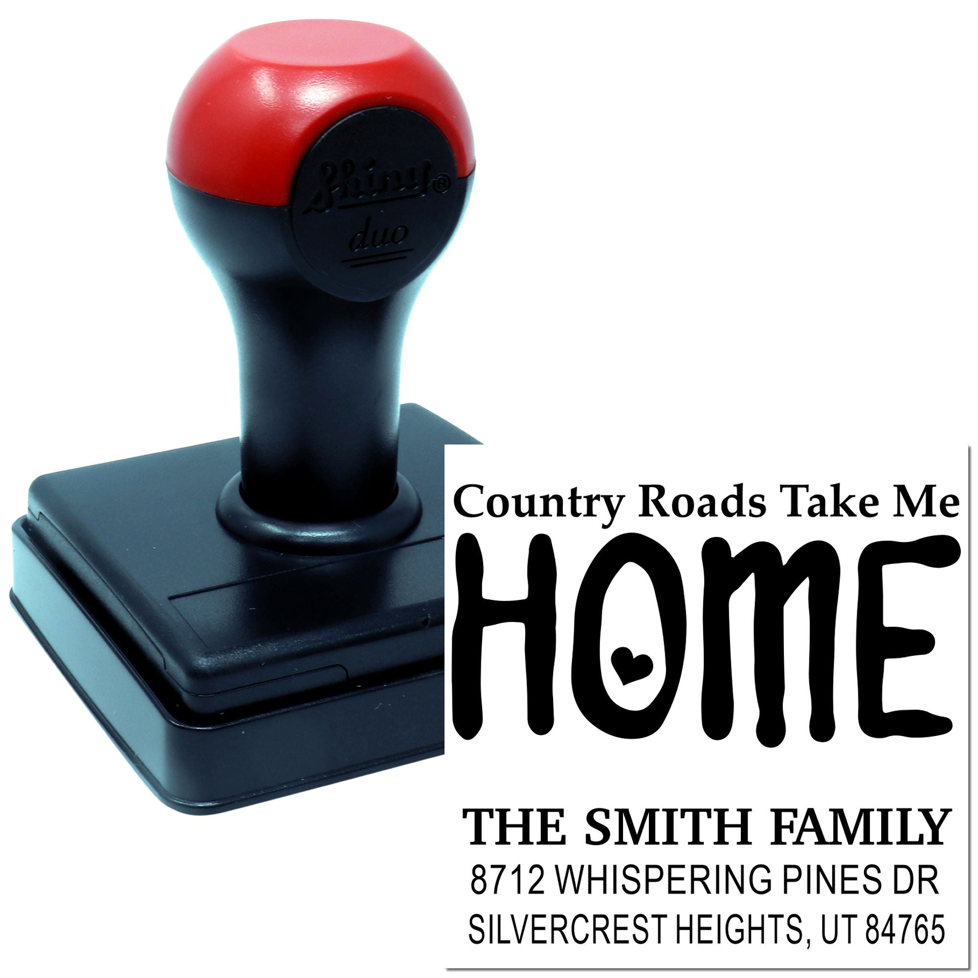 Self-inking address stamp with red-and-black handle showing Country Roads Take Me Home HOME, for The Smith Family with custom address text.
