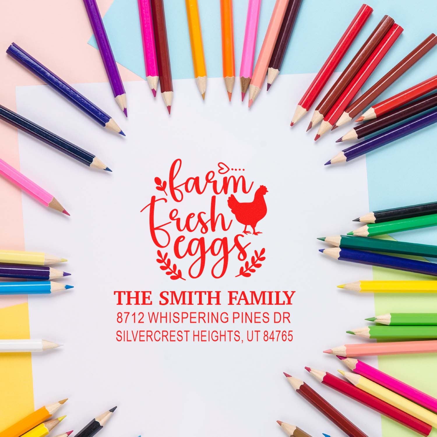 Custom Farm Fresh Eggs return address stamp with The Smith Family address, surrounded by colorful pencils on a pastel craft background.