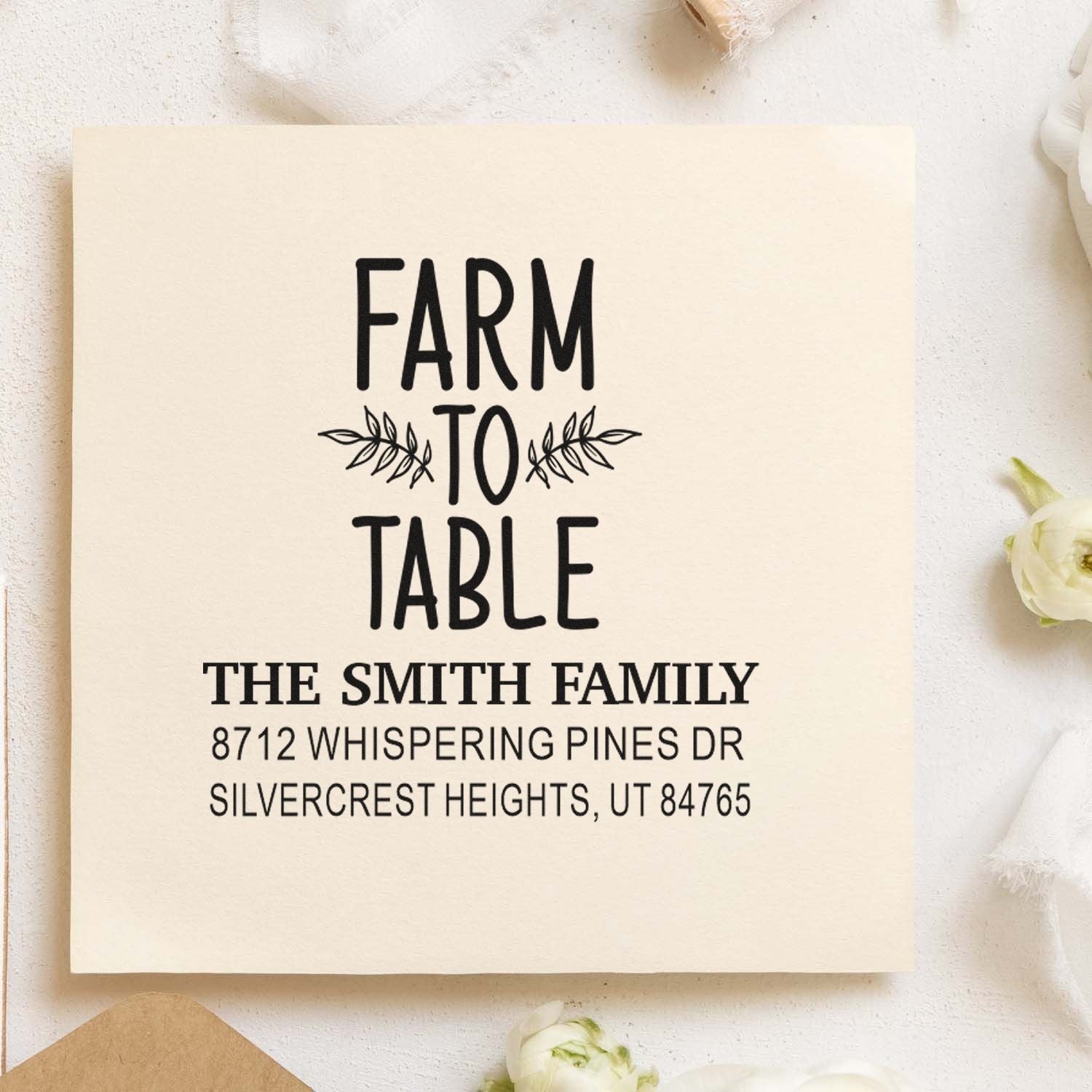 Custom Farm to Table address stamp for The Smith Family with leaf accents, shown on cream paper in a rustic stationery flat lay.