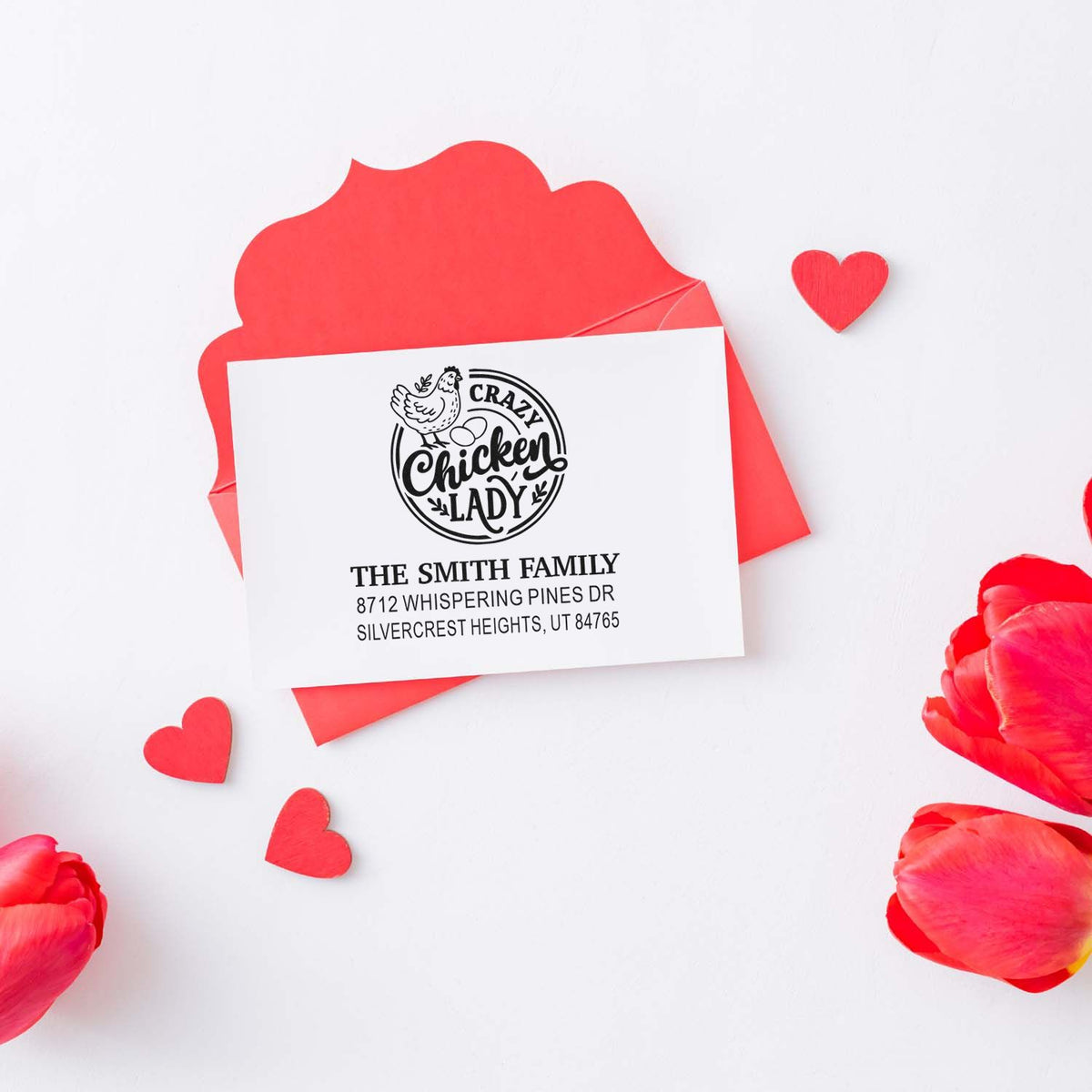 Personalized return address stamp with Crazy Chicken Lady design on a red Valentine envelope, surrounded by heart cutouts and petals.