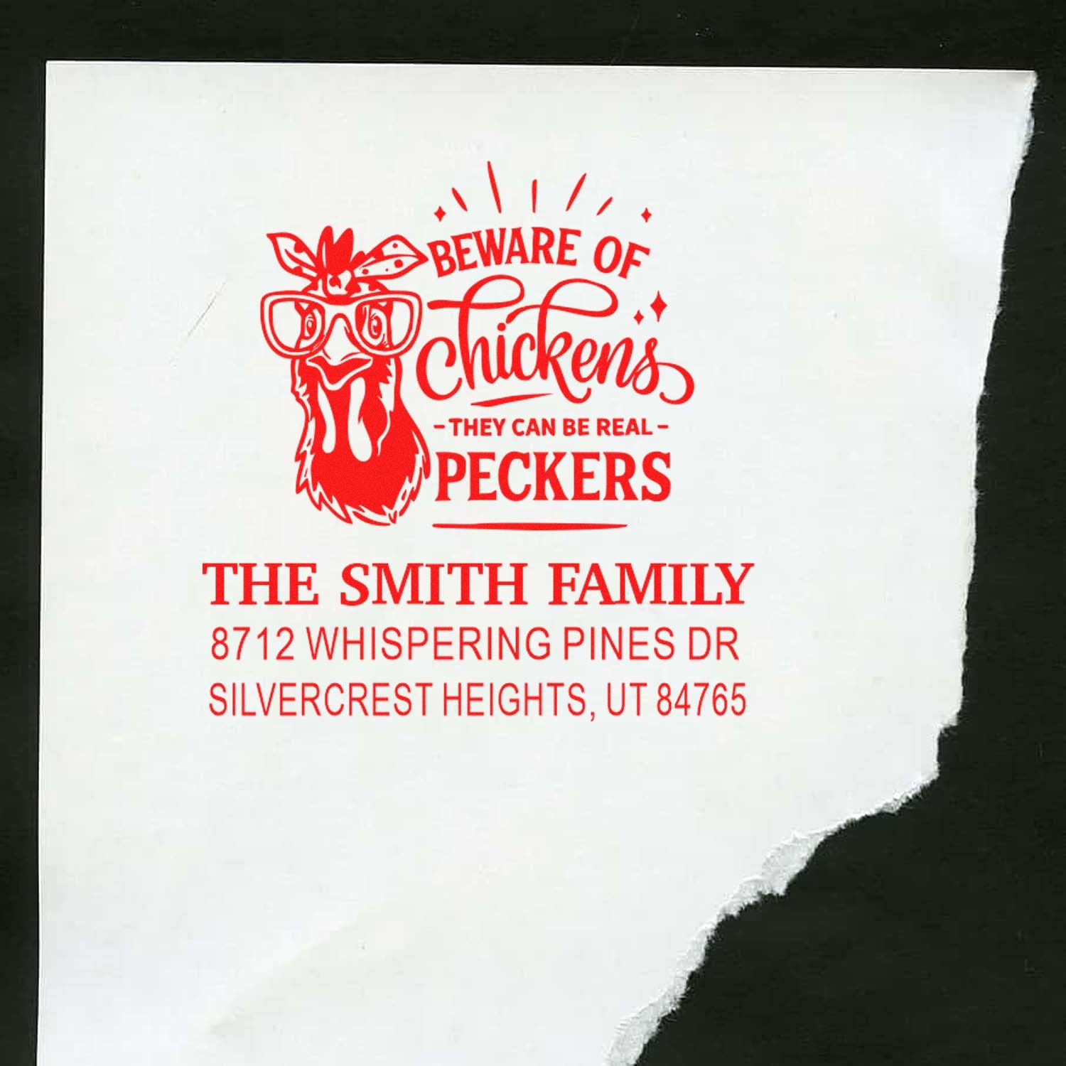Red custom address stamp with a bespectacled chicken graphic and Beware of Chickens slogan on white paper, featuring The Smith Family address.