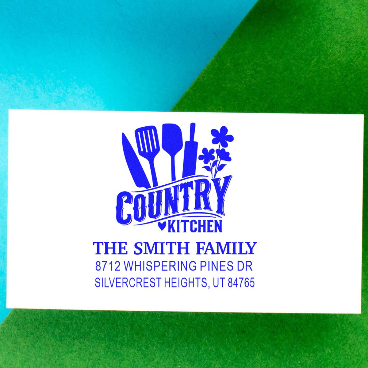 Custom blue Country Kitchen address stamp for The Smith Family with utensils, flowers and Utah address on white background.