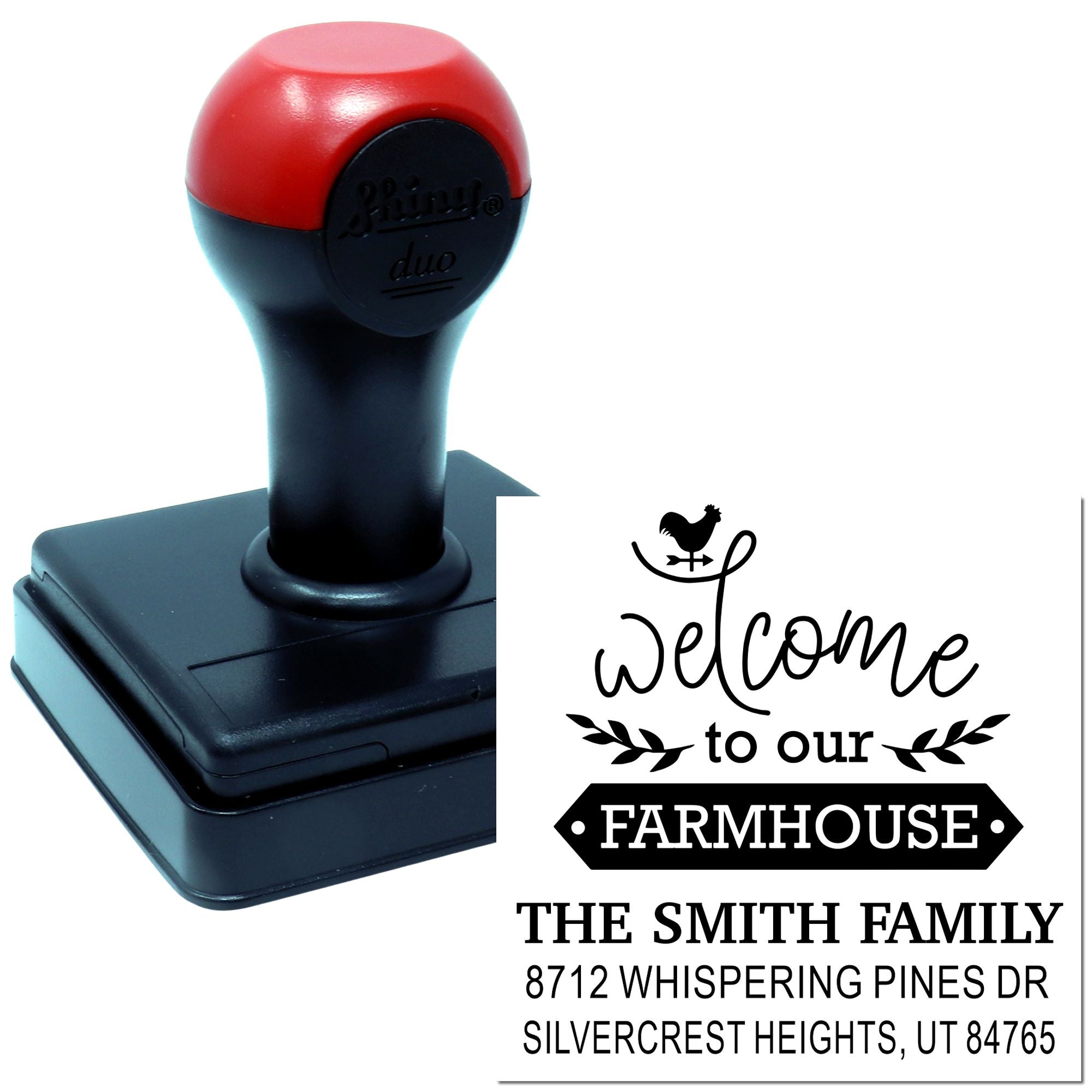Self-inking rubber stamp with red and black handle, displaying a custom farmhouse welcome address imprint for The Smith Family on a white background.