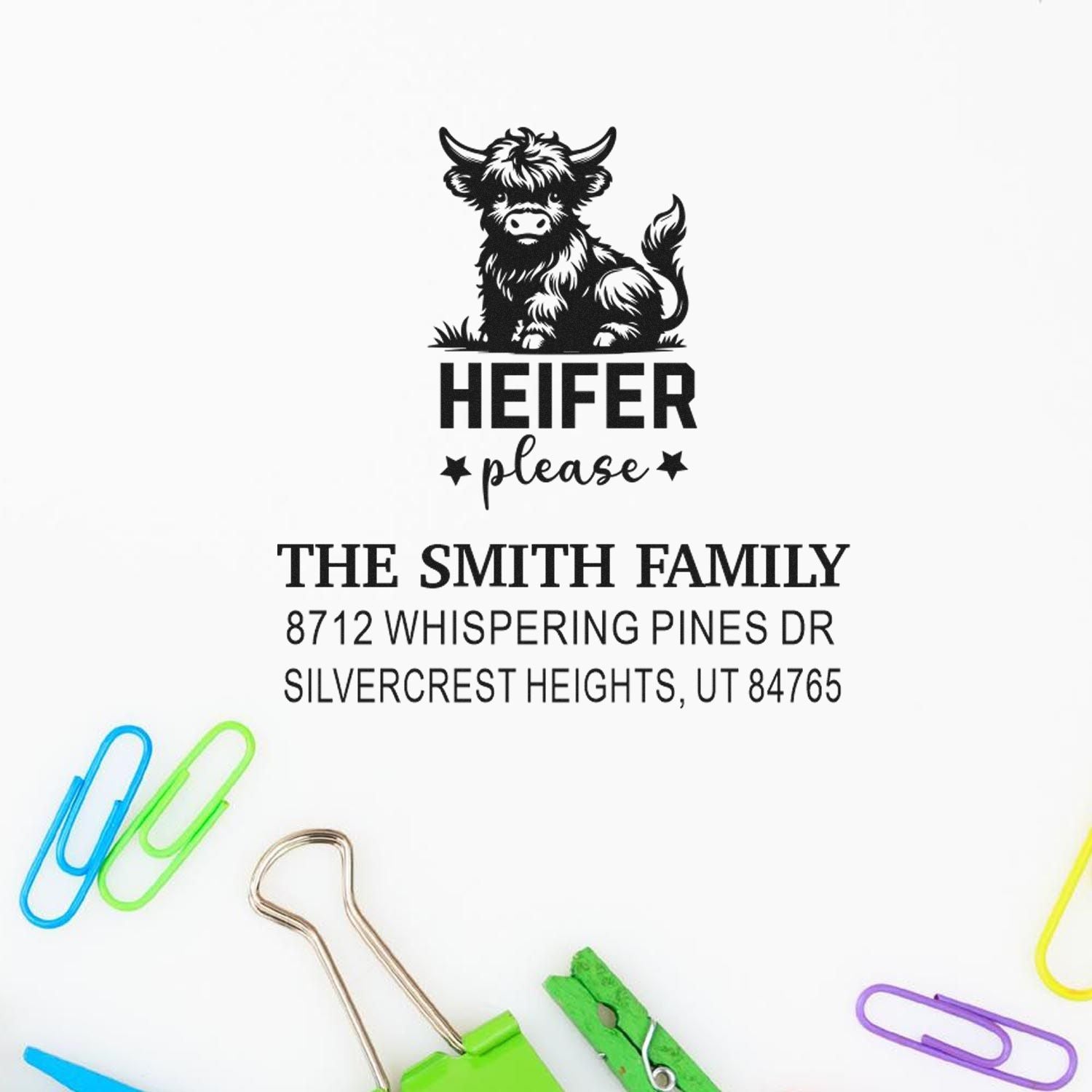 Custom self-inking address stamp with Highland cow Heifer please design, The Smith Family, Utah address, on white background with colorful paper clips.