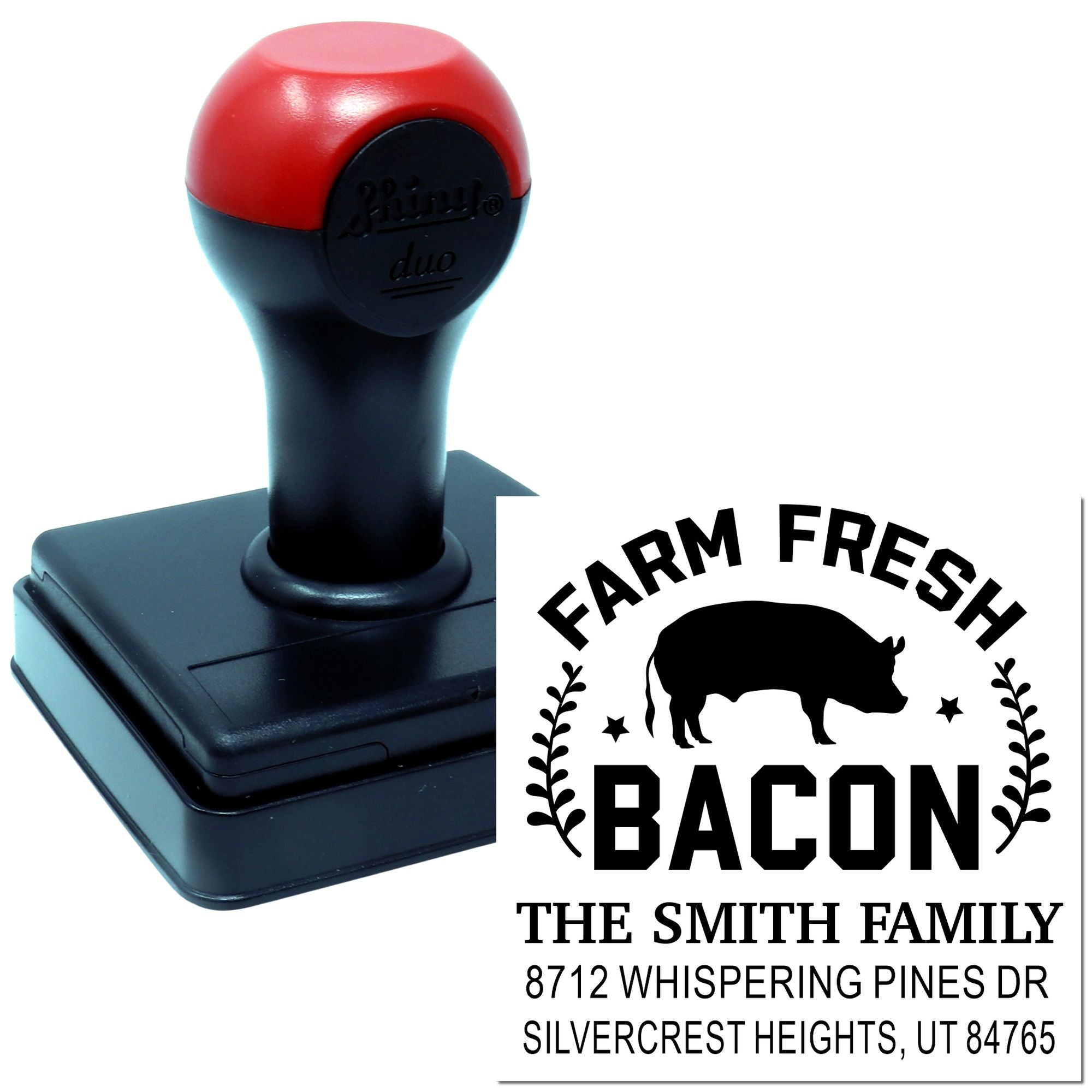 Custom self-inking farm fresh bacon address stamp with pig logo, family name, street address and city on a red-and-black stamp base.
