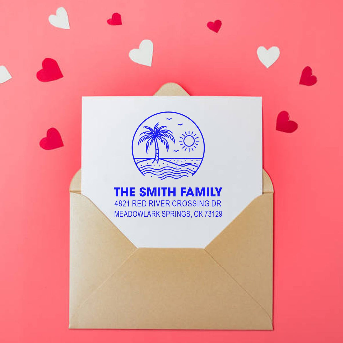 Custom address stamp on envelope with beach palm tree logo, The Smith Family return address, on pink background with scattered heart confetti.