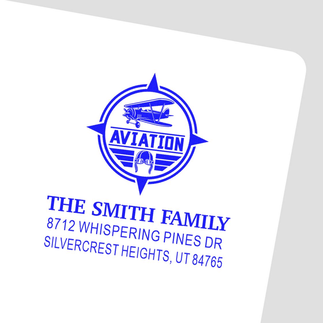 Blue aviation address stamp with biplane logo and compass design for The Smith Family, featuring 8712 Whispering Pines Dr, Silvercrest Heights, UT.
