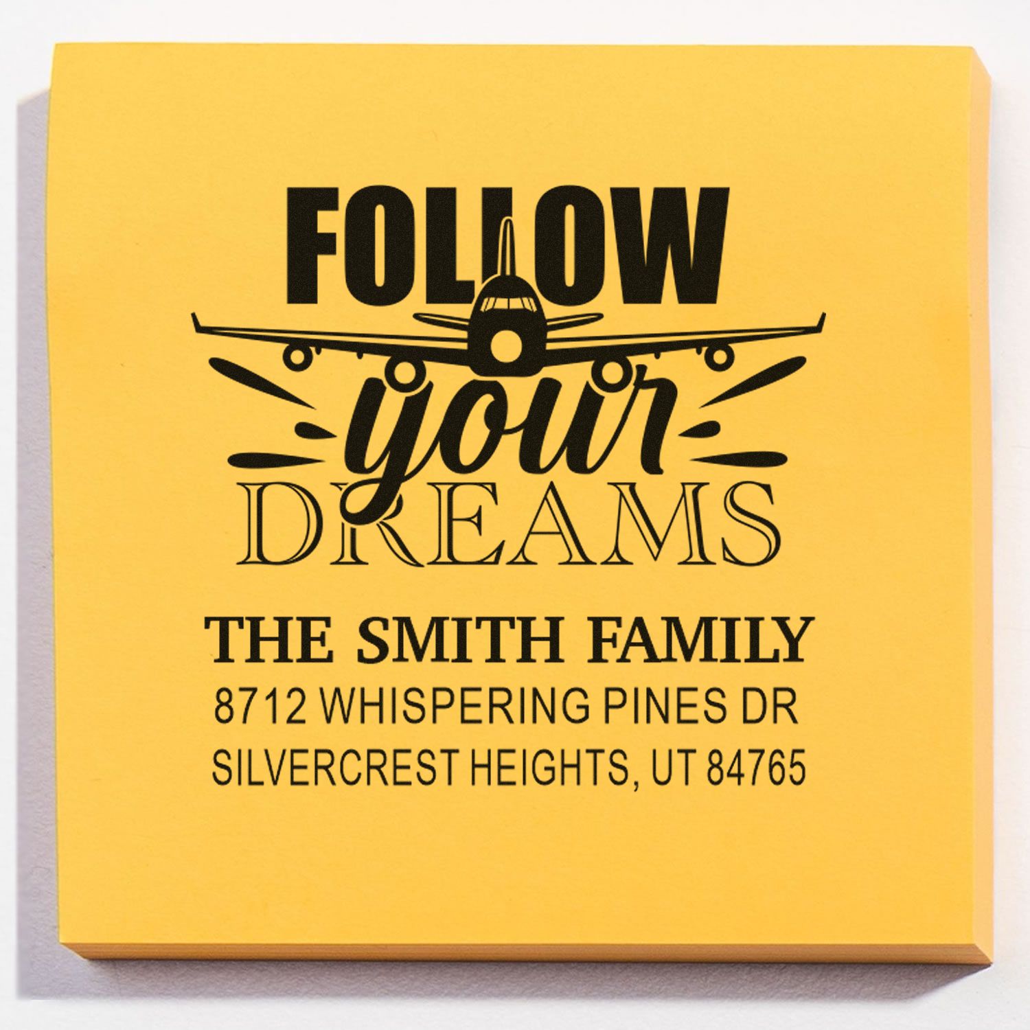 Custom yellow address stamp with airplane graphic and Follow Your Dreams text for The Smith Family, Silvercrest Heights, UT 84765.