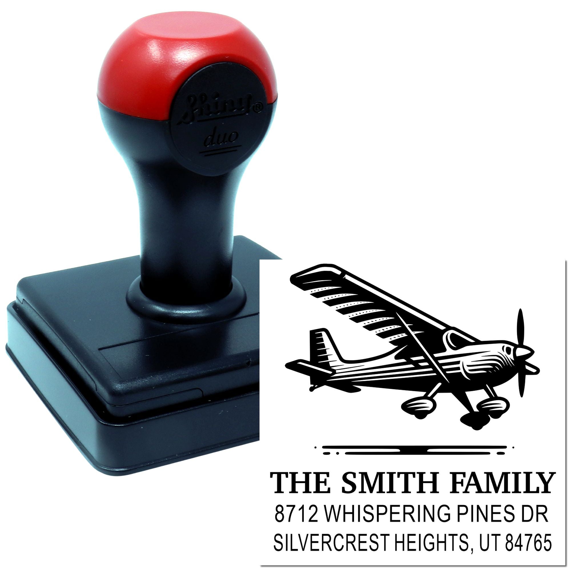 Custom self-inking address stamp with airplane graphic, shown with stamp device and printed impression for The Smith Family in Silvercrest Heights, UT.