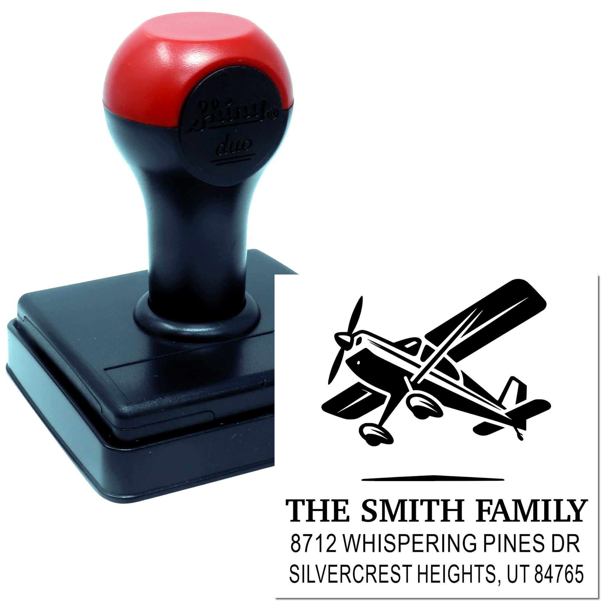Custom self-inking address stamp with airplane logo and The Smith Family return address on a white product display.